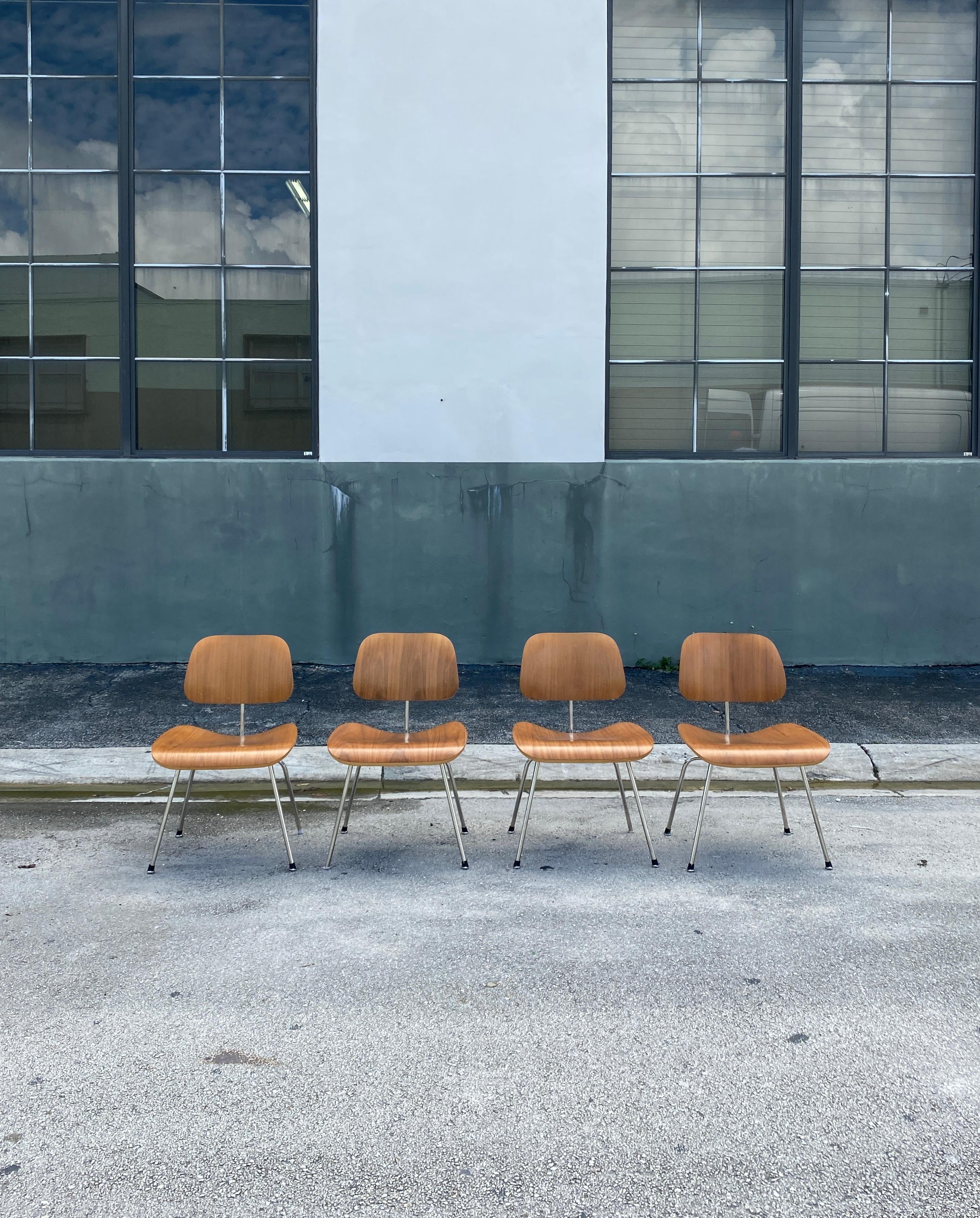 Vintage chairs fabricated from molded plywood seats and backs attached to a metal base, creating a minimal silhouette.

Wear consistent with age and use. Minor chips. Couple of caps missing. Chrome is in perfect condition, showing now signs of