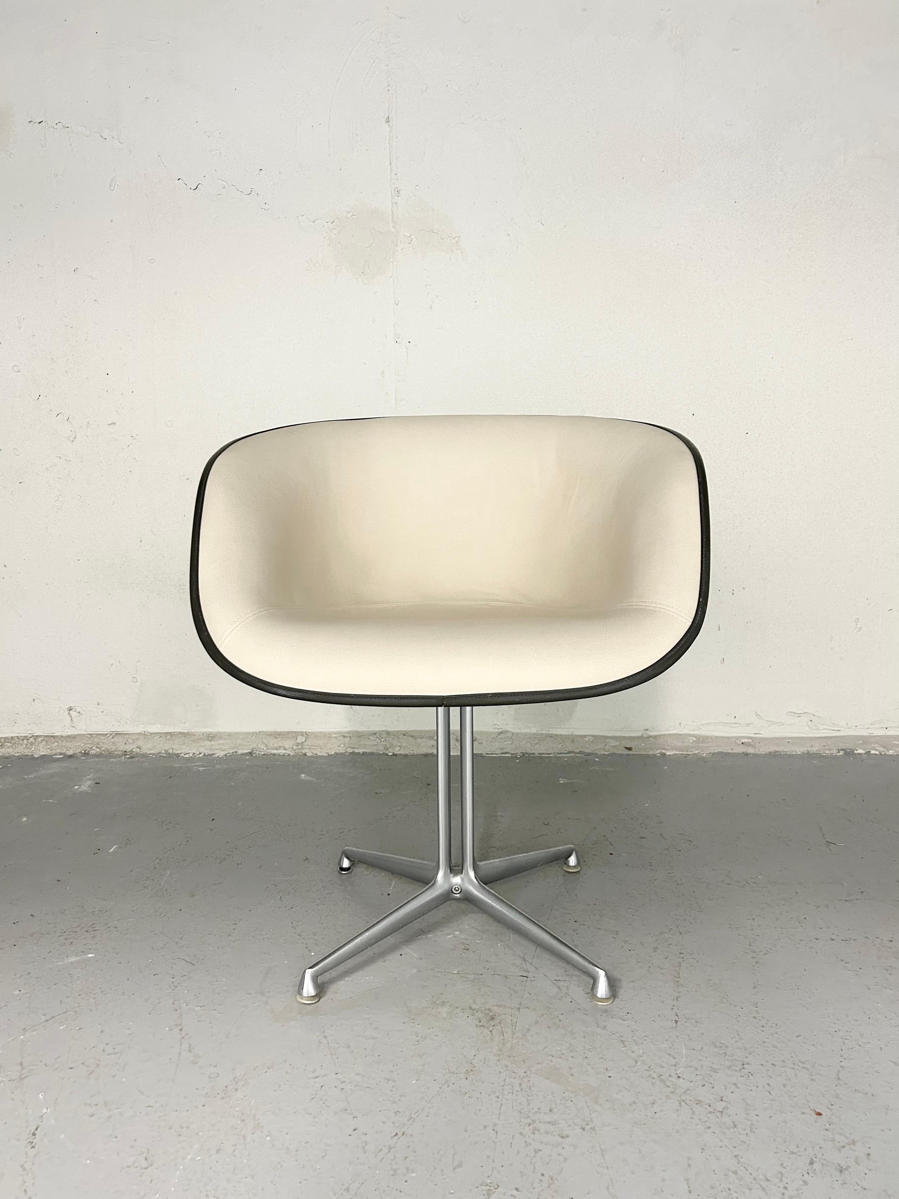 Vintage Eames La Fonda chair for Herman Miller from the 1960s. Original fiberglass shell and metal base - new faux leather upholstery with original dark binding trim. 

Measures: 29” height.
19” seat height.
25” width.
25” depth.