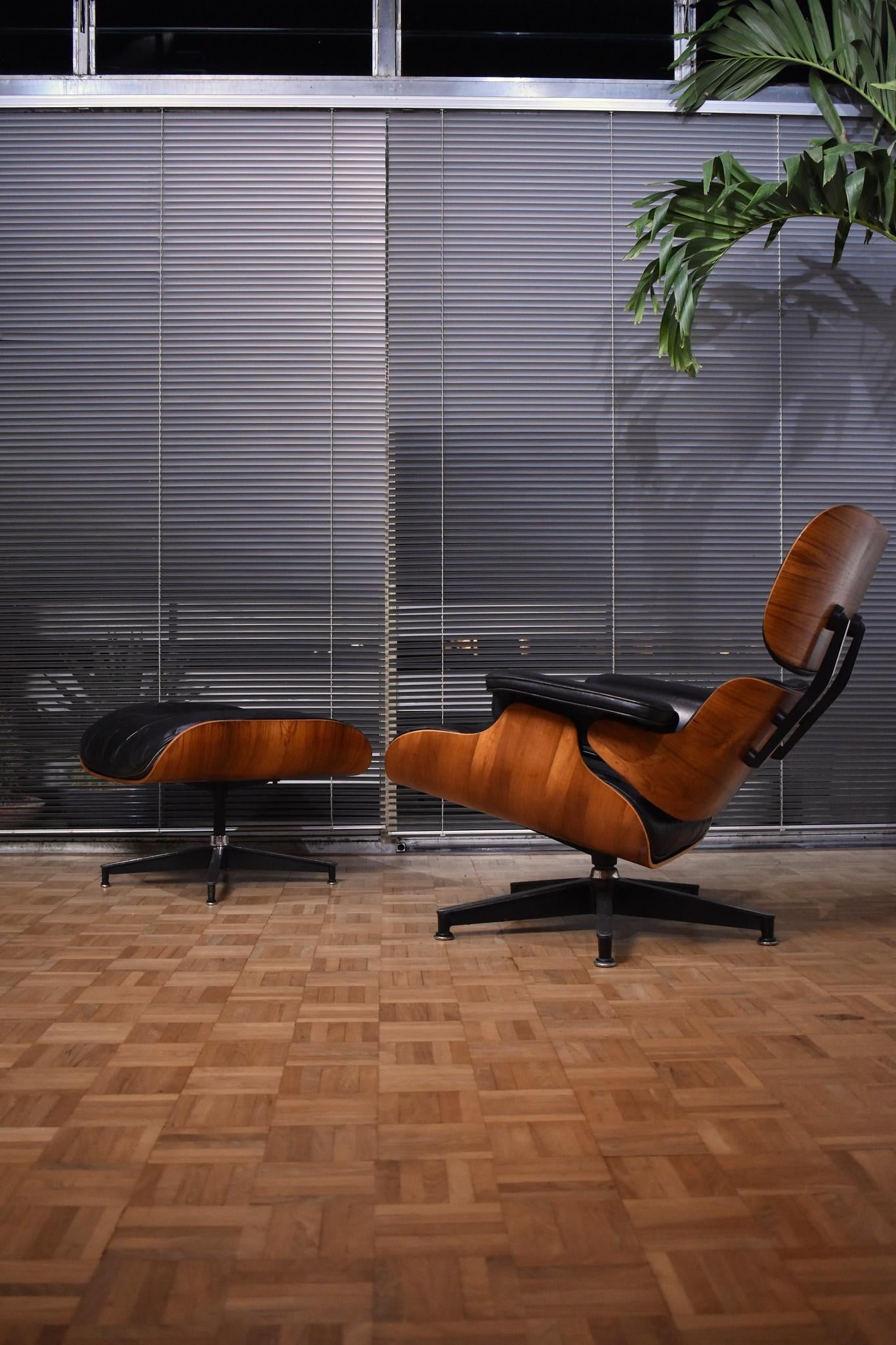 A particularly nice Brazilian rosewood and black leather Eames lounge chair & ottoman produced by Herman Miller.

This is what some would describe as a second generation chair with cushions filled with a mixture of latex and feather. In our