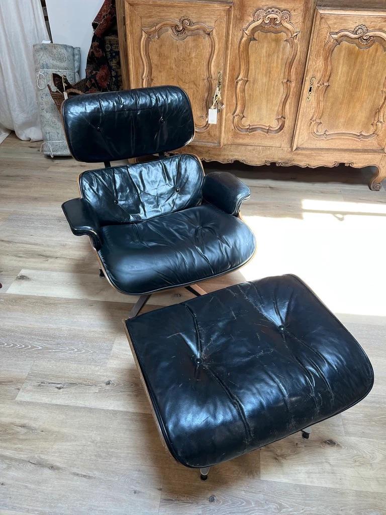 Vintage Eames Rosewood Lounge Chair, c. 1965.  Black leather with wear and some slight damage but having a  fine patina.    30.75” h. x 32” d. x 32” w. (the chair).

