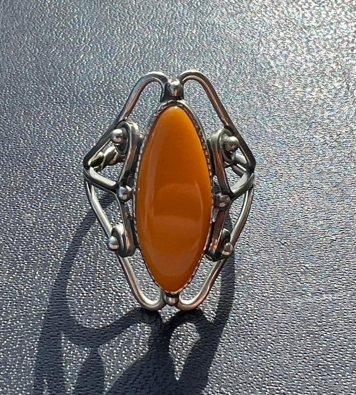 Rare solid Orange-yellow amber ring handcrafted in Latvia.  This unique ring was a part of my late grandmothers robust collection of amber jewelry.  She brought the pieces over on a boat while escaping Russian occupation in Latvia after World War 2.