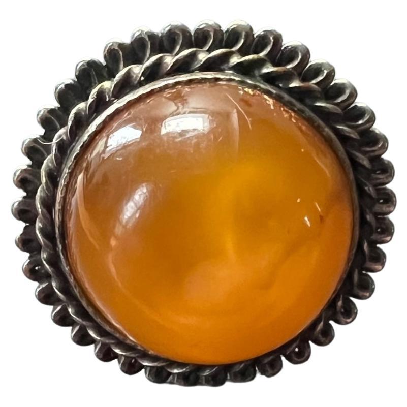 Rare amber ring handcrafted in Latvia.  This unique ring was a part of my late grandmothers robust collection of amber jewelry.  She brought the pieces over on a boat while escaping Russian occupation in Latvia after World War 2.  This early amber