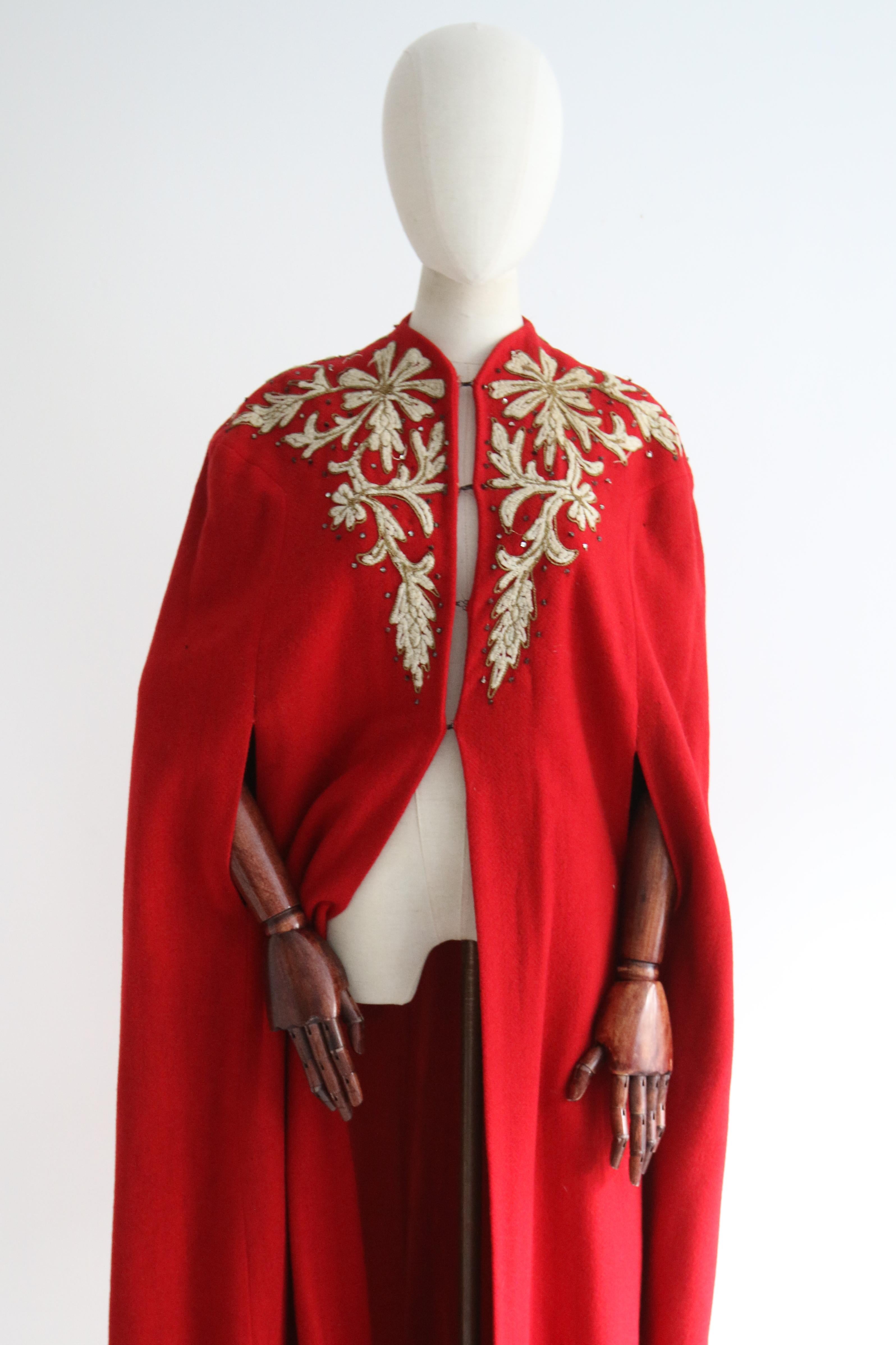 The most majestic and eye-catching cape you could ever set your eyes upon. Rendered in vibrant shade of red wool and decorated with cream wool soutache embroidery, edged with gold lamé soutache embroidery, in a trailing floral design, and finished