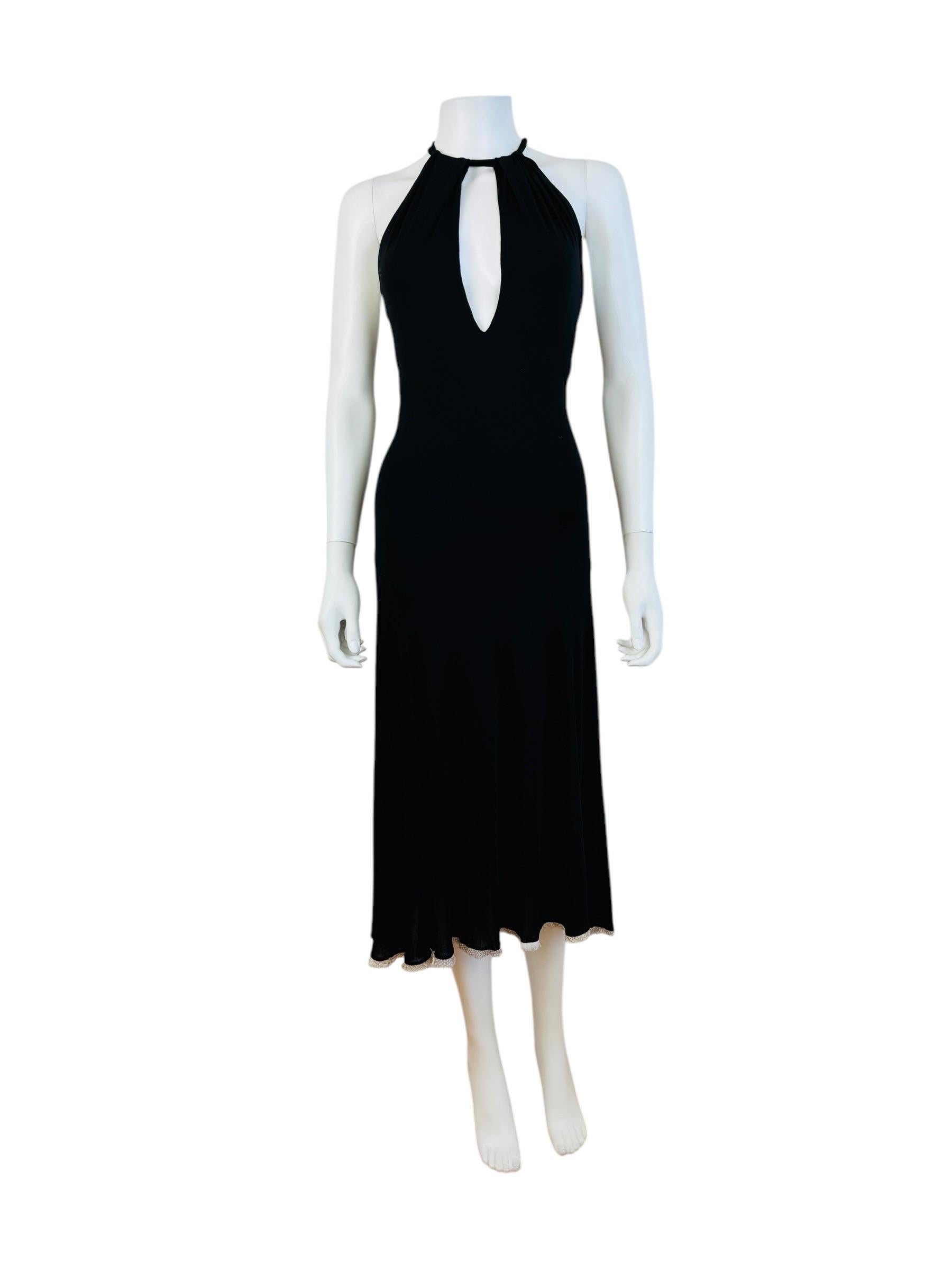 Early 2000s Roberto Cavalli Dress
Black stretch viscose knit fabric
Halter neckline with sash that ties at the back of the neck
Keyhole cut out at the bust + upper back
Thin layer of reptile print fabric at the hemline
Midi length
Slight hi low