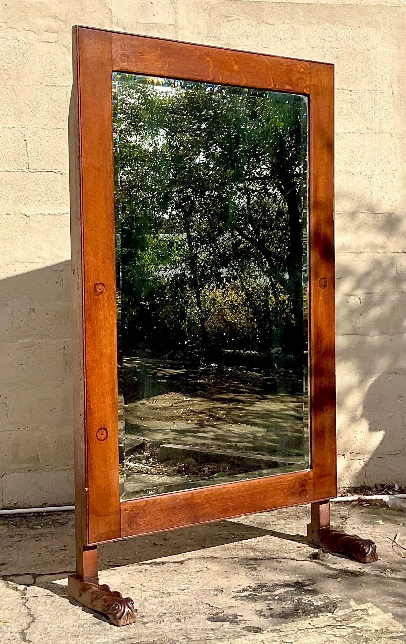 A stunning vintage Boho floor mirror. A chic stained oak from with a beautiful patina from time. Handsome carved feet make this a real showstopper. Monumental in size and drama. Acquired from a Palm Beach estate.