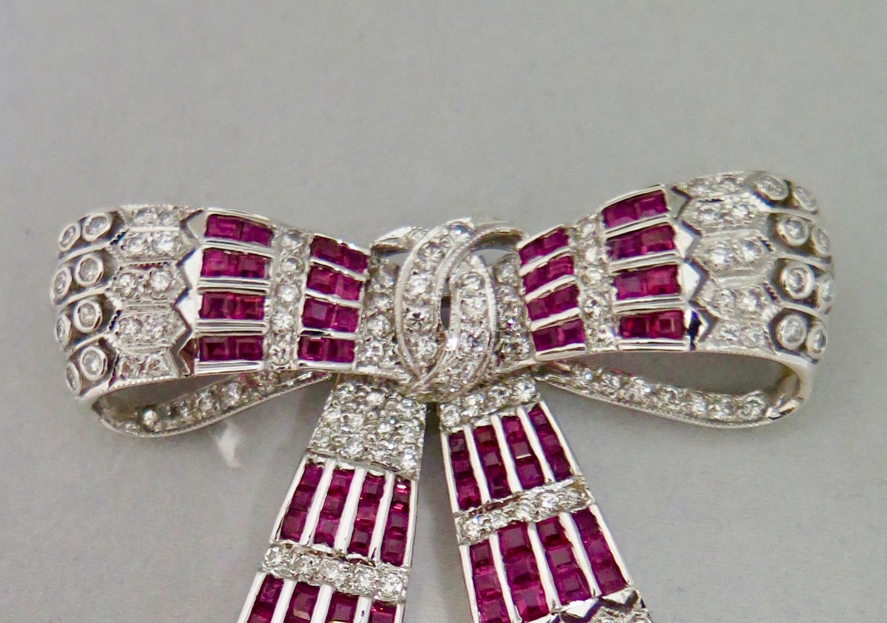 This vintage early 20th century 18-Karat gold jeweled bow brooch is designed with a dazzling array of sparkling diamonds and rubies. The bow is embellished with 158 diamonds (1.75 carats) and 80 rubies (3.08 carats) creating a stunning jewelry