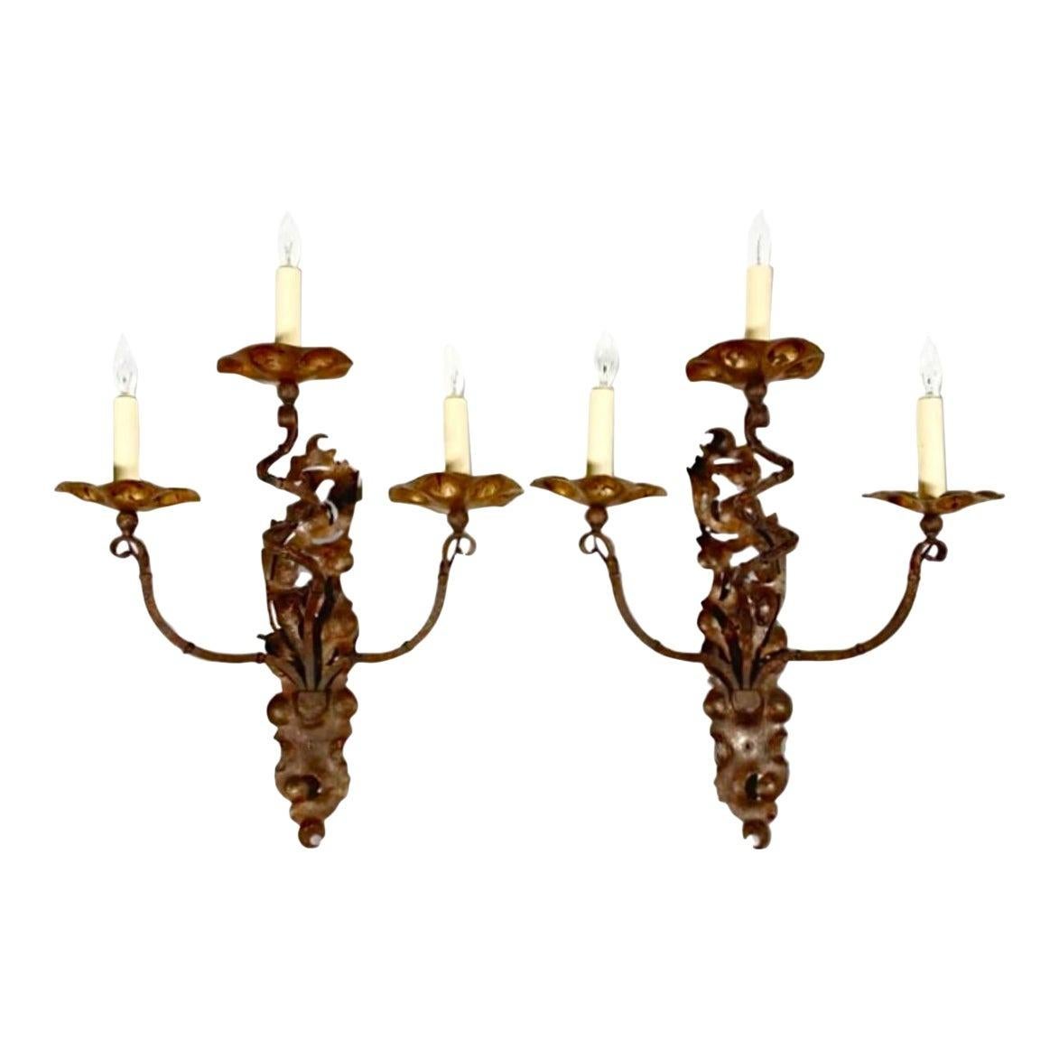A stunning pair of vintage Italian iron sconces with gilt metal and distressed finish. Acquired at a Palm Beach estate.