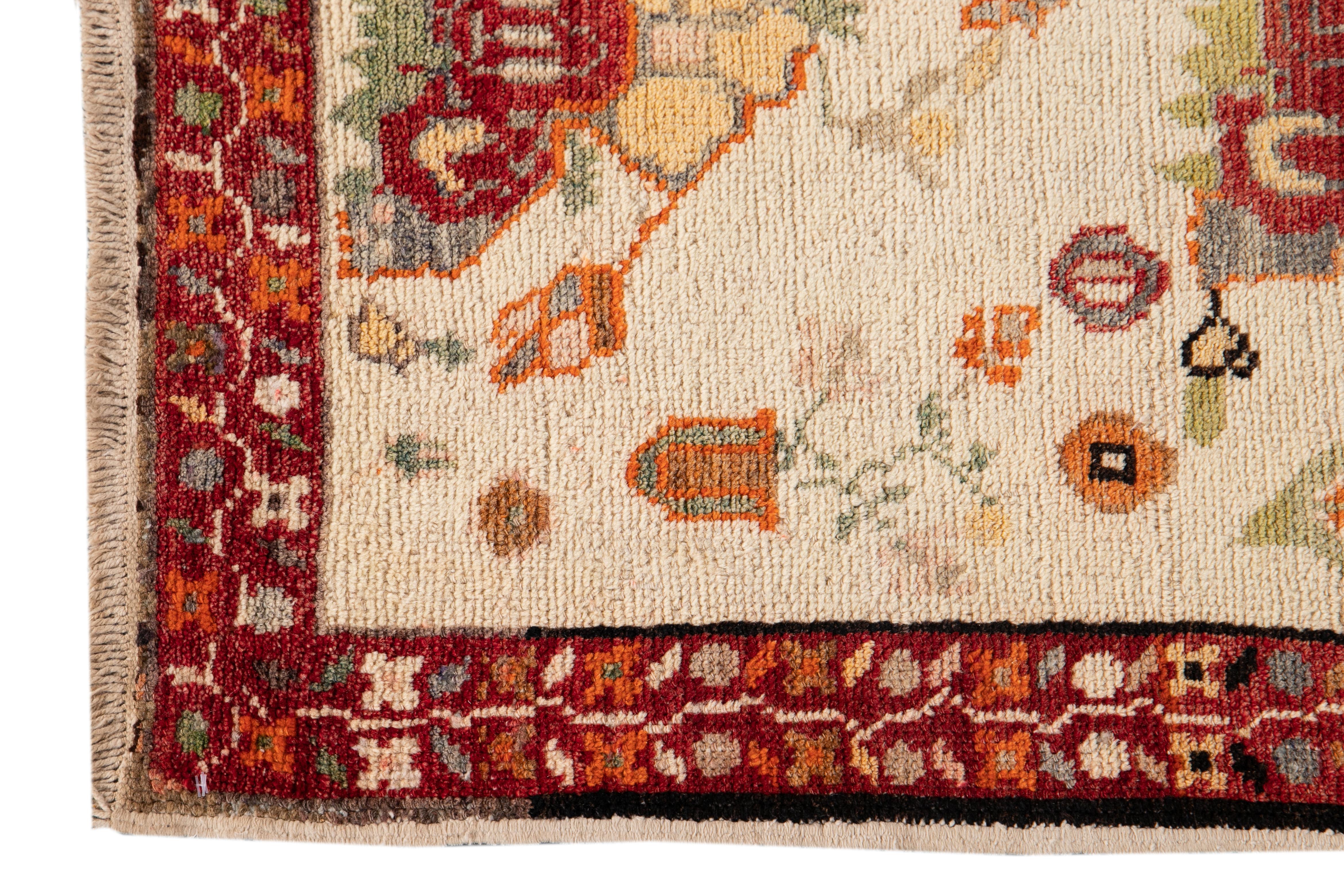 Beautiful Antique Khotan Runner rug with an ivory field and red border with an all over floral design. 

This rug measures 2' 9