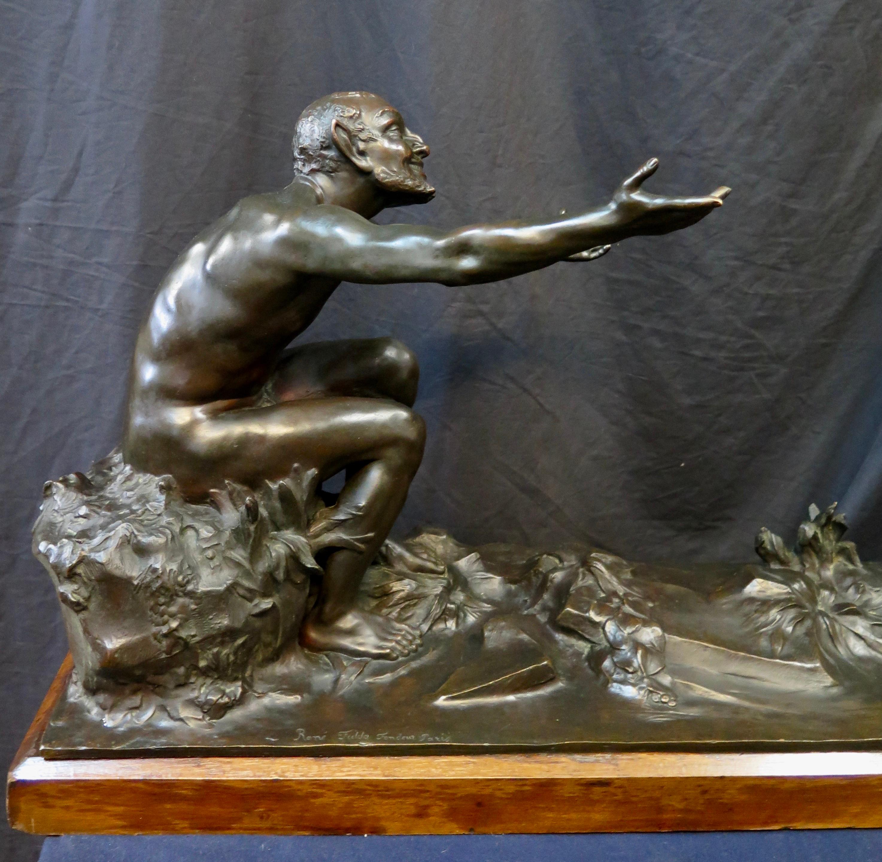 This large French vintage patinated bronze sculpture dates from the early 20th century. The artist, Etienne Forestier, depicts a beautifully rendered detailed mythological scene with skillful accuracy. A young satyr sits with outstretched arms,