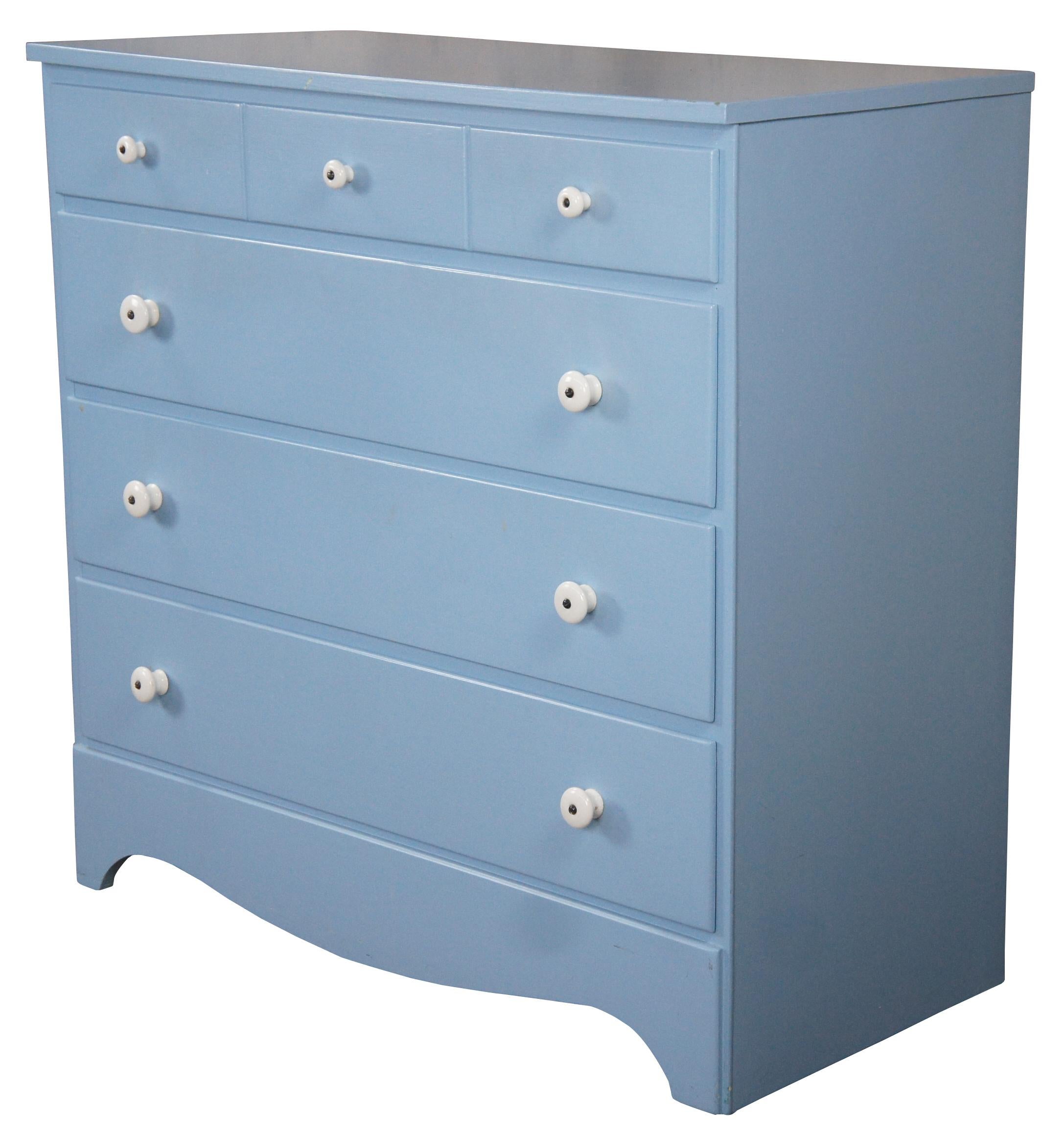 Vintage Early American style painted four drawers chest or dresser featuring North Carolina blue with white porcelain knob pulls.
  