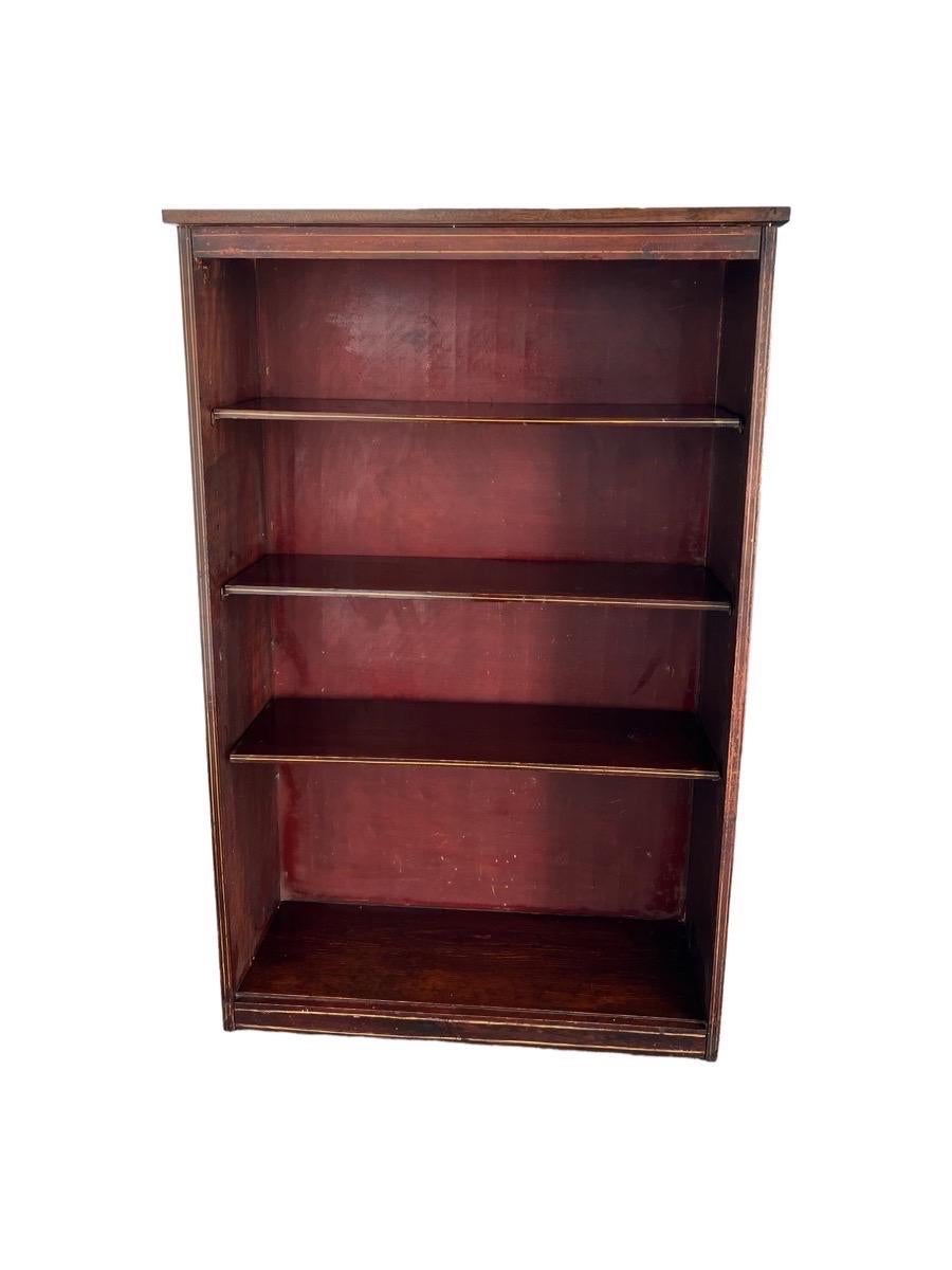 Vintage early American bookshelf with mahogany finish.

Dimensions. 31 W; 11 1/2 D; 48 H.