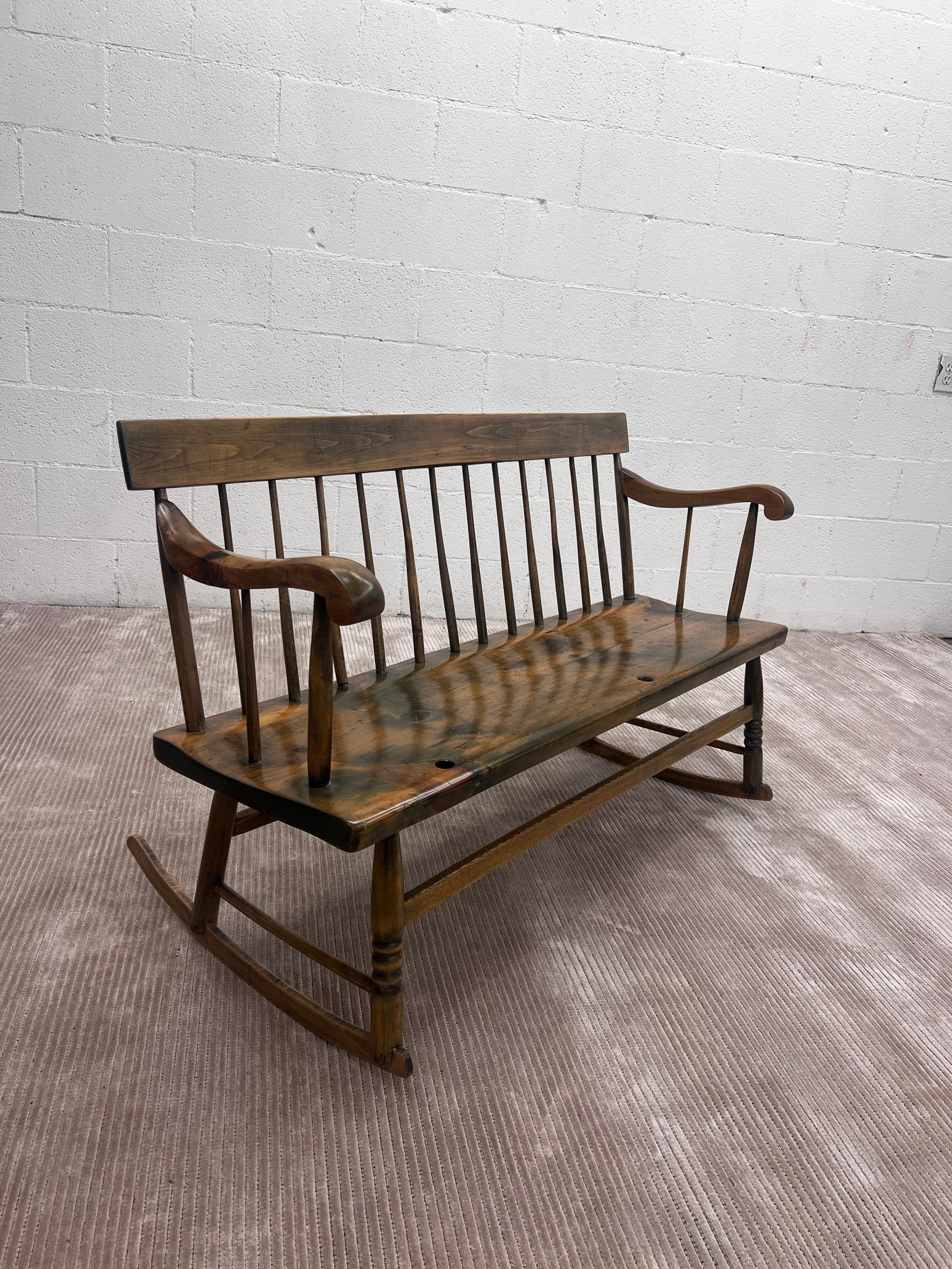 19th Century Pine Wood Spindle ‘Nanny' Bench With Removable Front Guard. 
Constructed out of solid knotty pine wood. 

A Long narrow rocker great for a mud room or as a entryway hall bench. 
In excellent restored condition. New satin finish. 


Seat