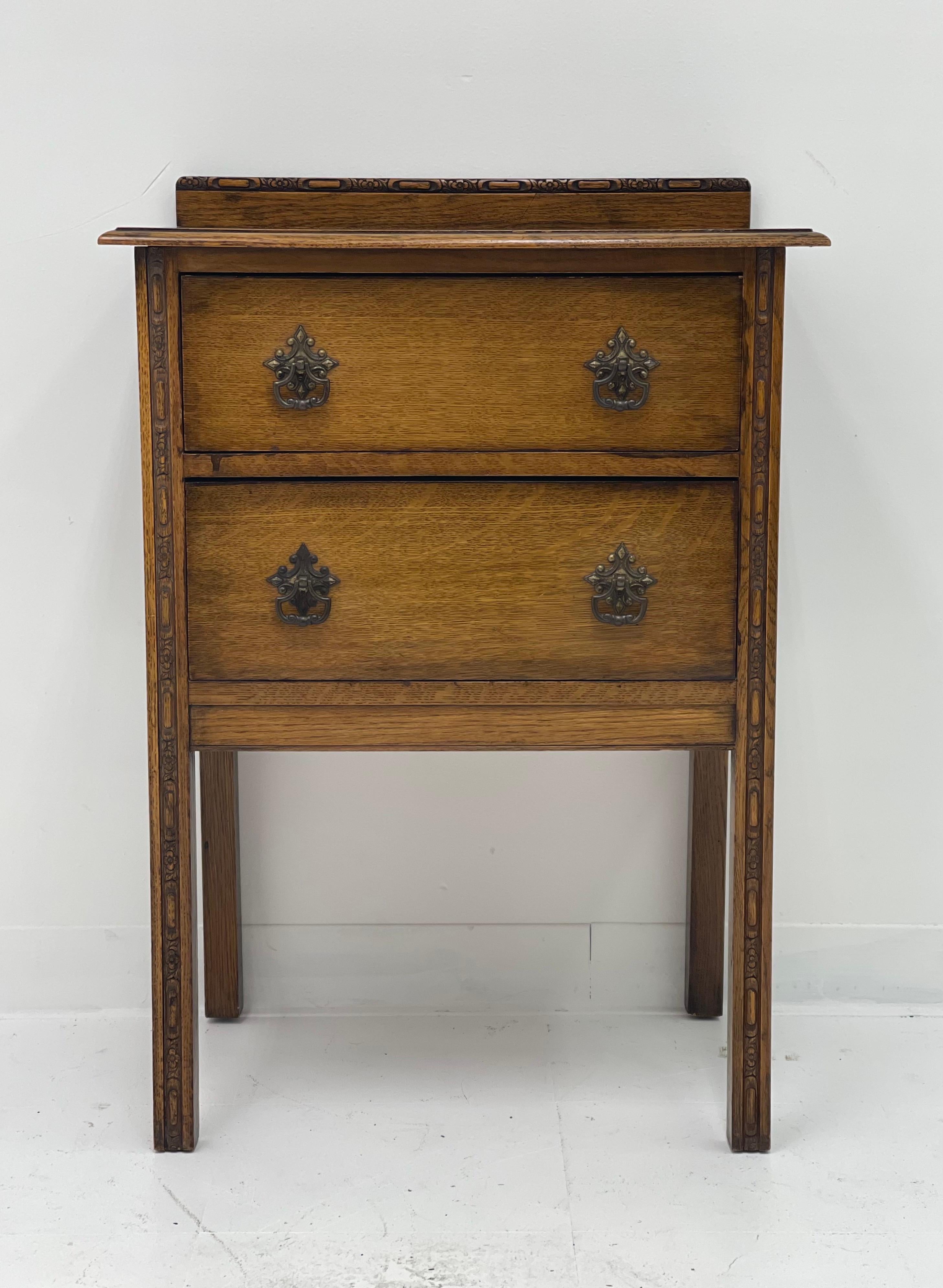 Antique Early American oak 2 drawer dresser base with square legs and a lovely shaped top apron with hand carved details.