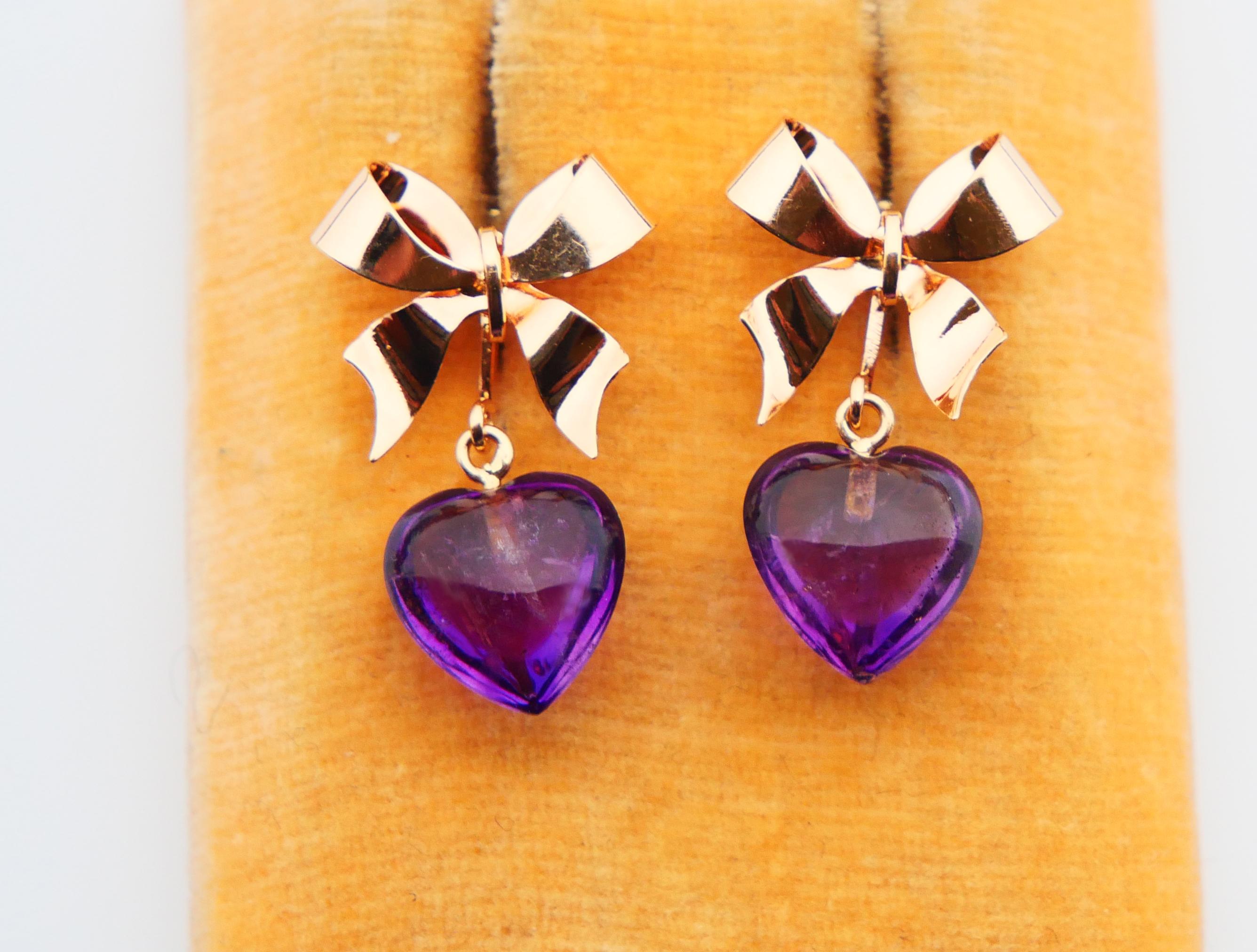Vintage Earrings with Bows and Amethyst Hearts in solid 18K Gold,likely Swedish from 1950s -1960s. Stoppers hallmarked 18K,no date marks.
Natural Amethyst Hearts about 1 ch x 1 cm x 6 mm deep each. Transparent stones with peculiar natural