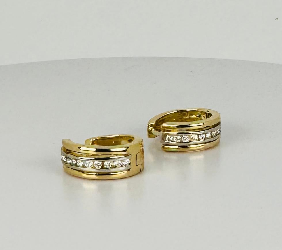 Beautiful creoles with diamonds made of 14 carat yellow gold. This vintage jewel is set with 10  brilliant cut diamonds each, with a total weight of about 0.20 carat. These vintage earrings emphasize the sense of timeless class and elegance.  Weight