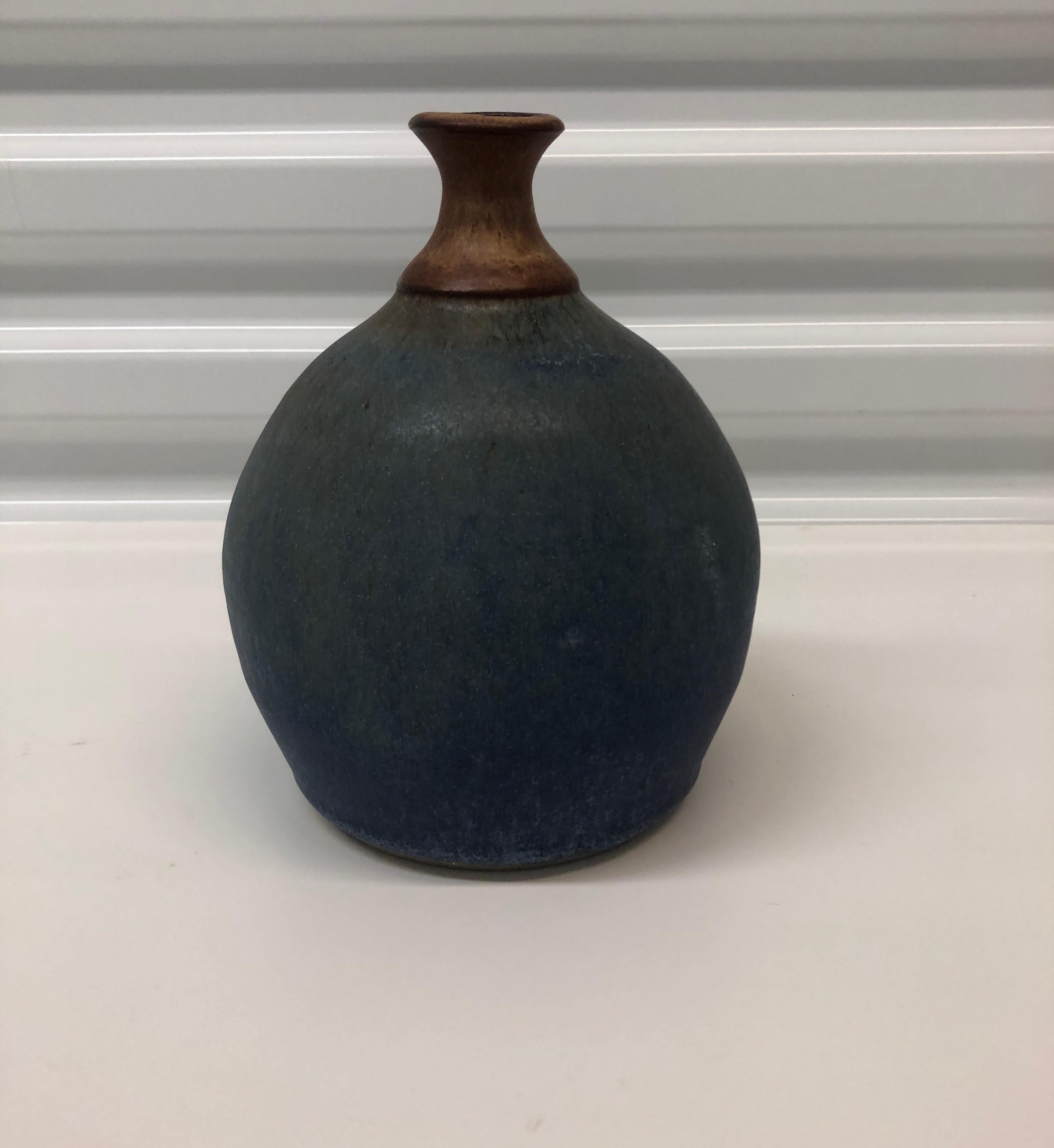 Vintage earthenware round turquoise vase.
Size: 6” D x 8” H.