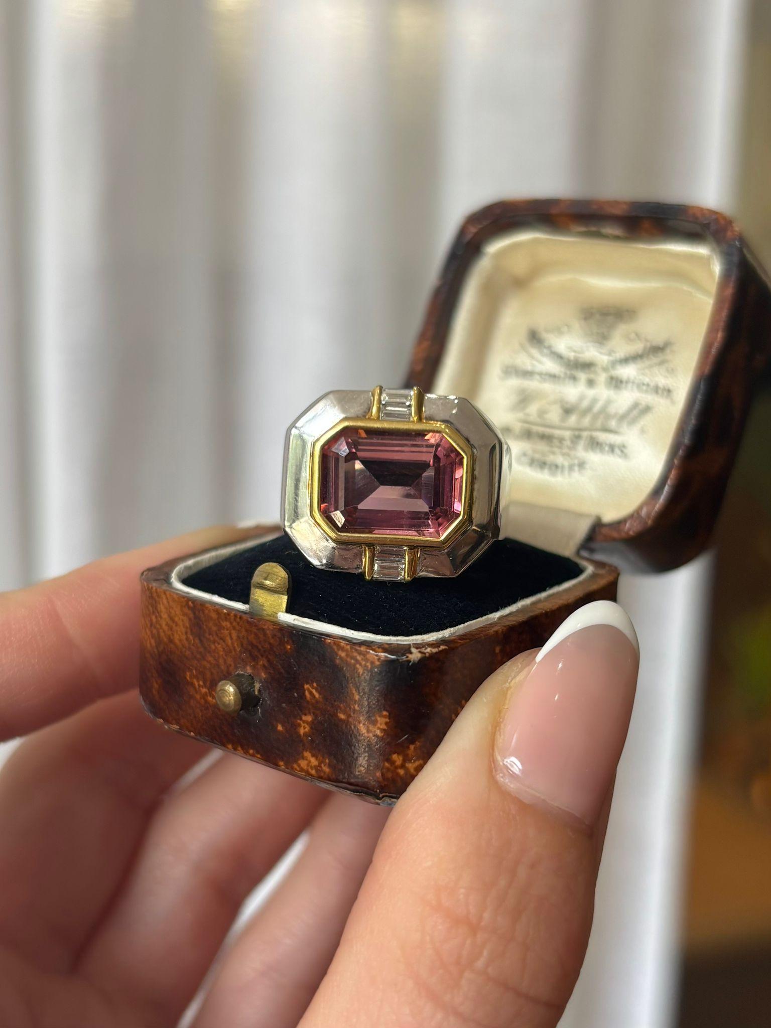 A striking vintage East-West 6.75ct pink tourmaline and diamond cocktail ring set in 18k yellow and white gold. 

The ring is centrally centrally set with a large 6.75ct pink tourmaline, set East-West in a yellow gold rub over setting. To the top