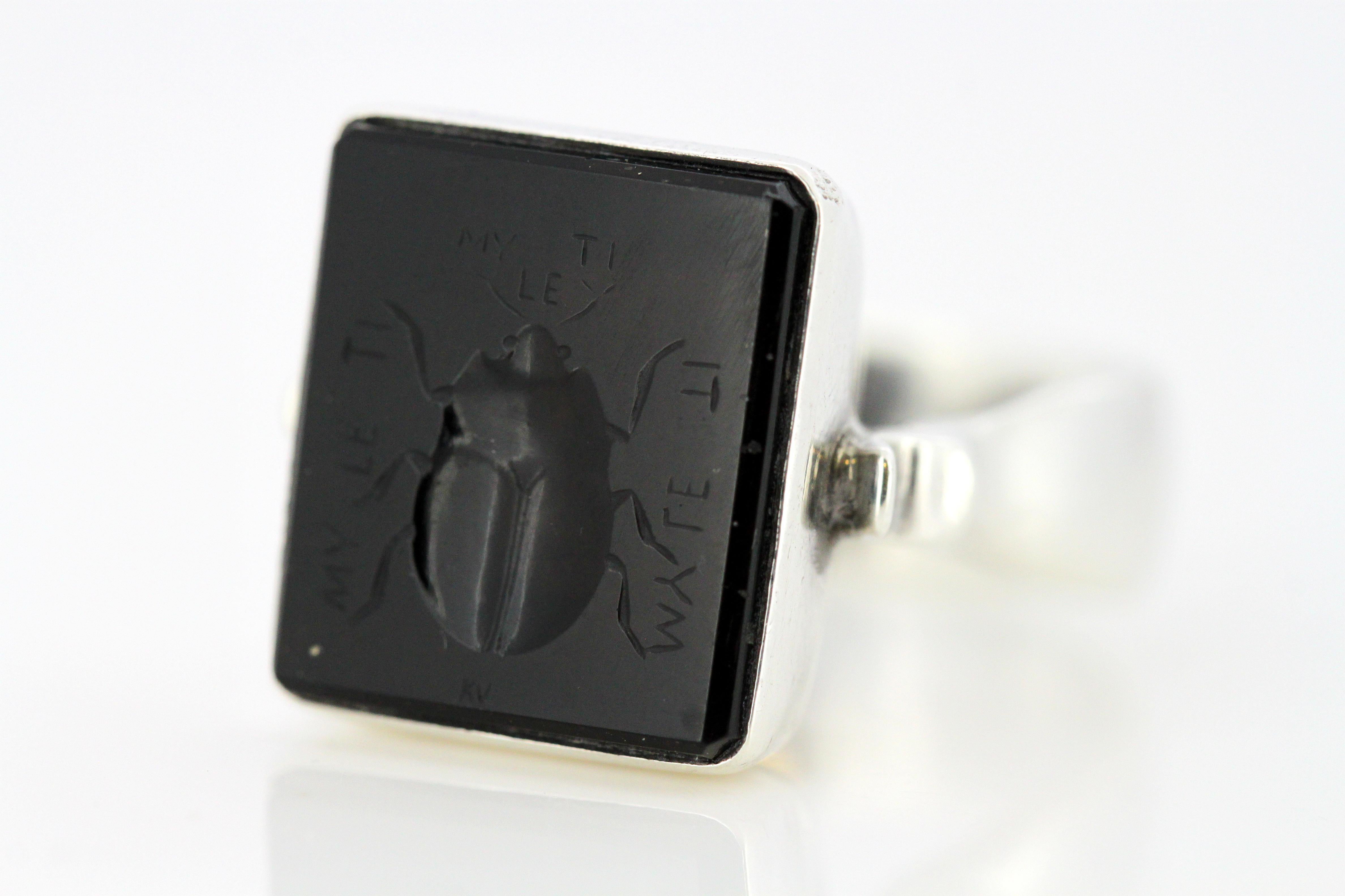 Vintage eastern European sterling silver signet ring with onyx scarab carving
Hallmarked 925
Maker : Unidentified
Circa 1950's

Dimensions -
Finger Size : (UK) = O (US) = 7 1/2 (EU) = 55 1/4
Size : 3.15 x 2.1 x 1.7 cm
Weight: 10 grams