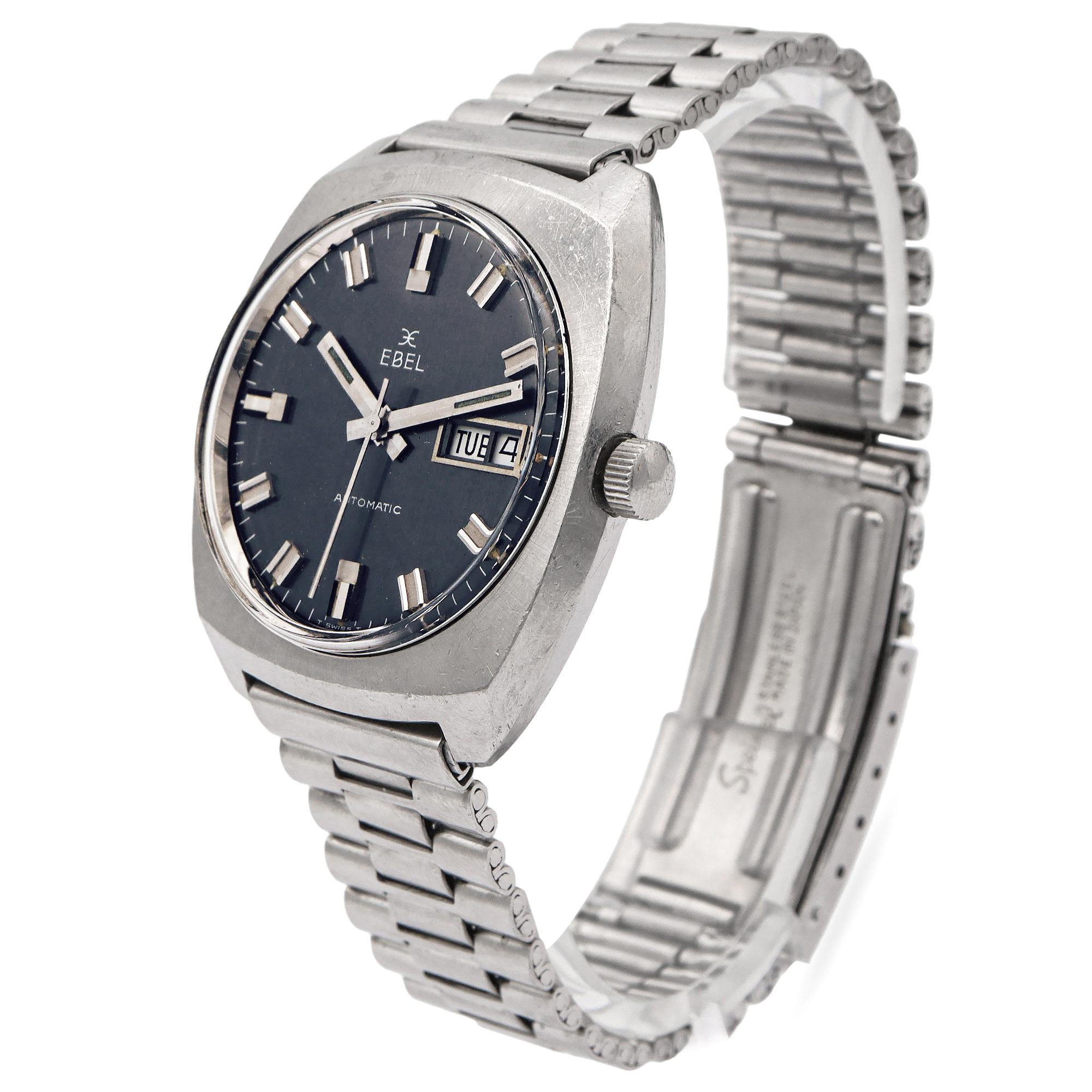 This is a vintage Ebel automatic wristwatch, embodying the bold and functional design of the 1970s. It features a cushion-shaped stainless steel case paired with a matching stainless steel bracelet, delivering a strong, industrial aesthetic. The