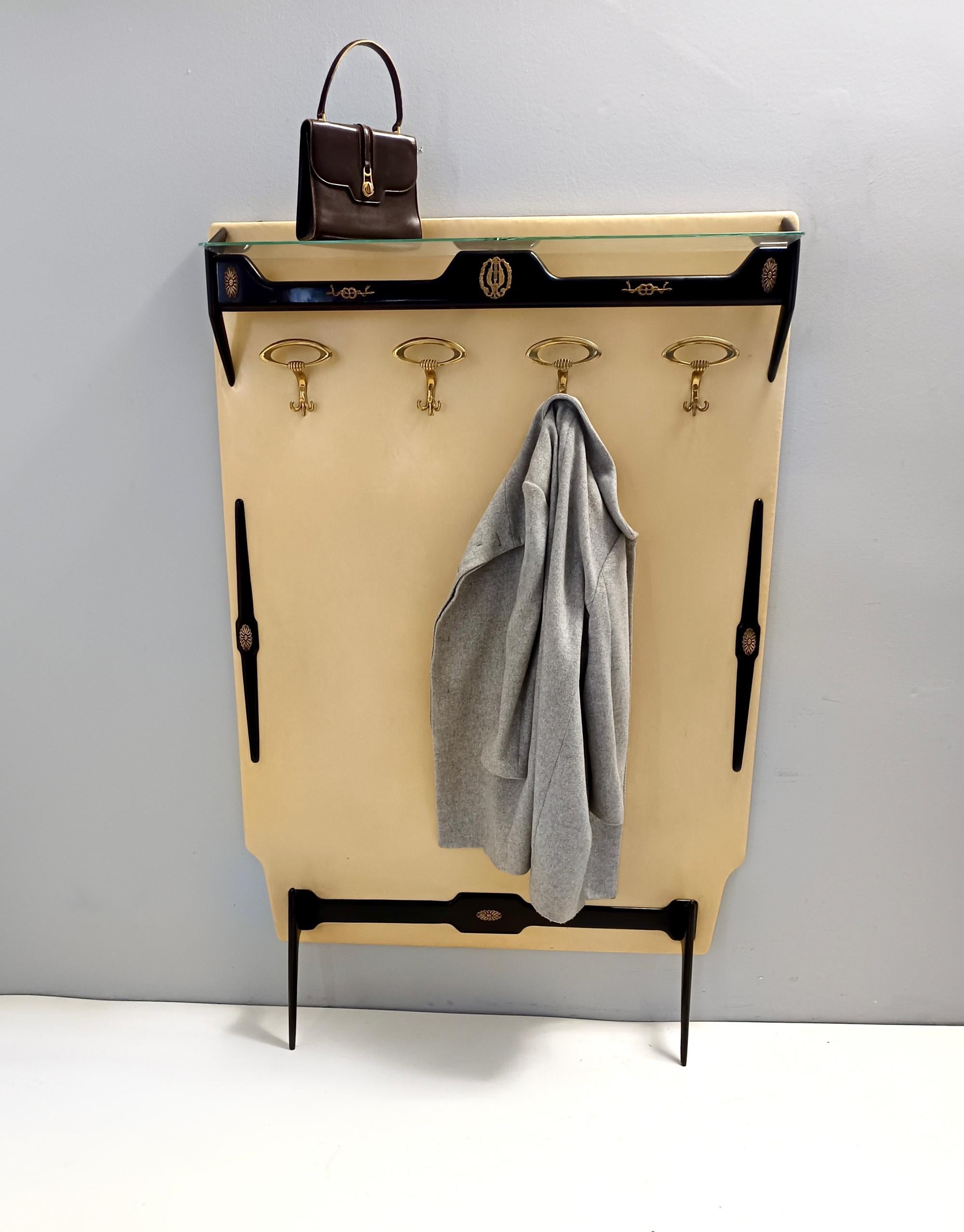 Made in Italy, 1950s.
It is made in ebonized beech, brass and glass and features a skai covered panel.
This is a vintage piece therefore it might show slight traces of use, but it can be considered as in very good original condition and ready to