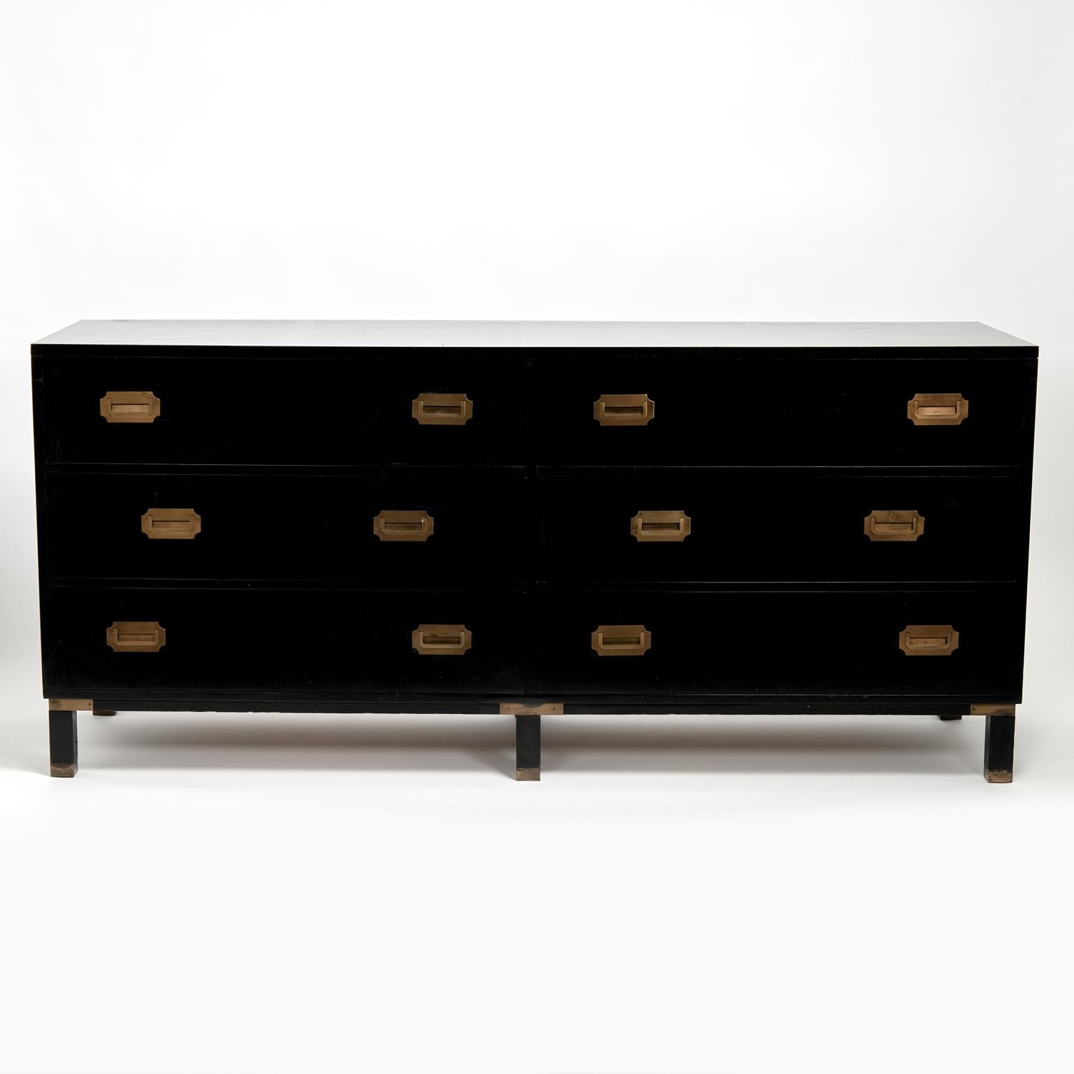 Chic mid century ebonized chest crafted in a modern campaign form with six drawers, brass hardware and straight legs with brass caps. Signed Milling Road in a drawer.