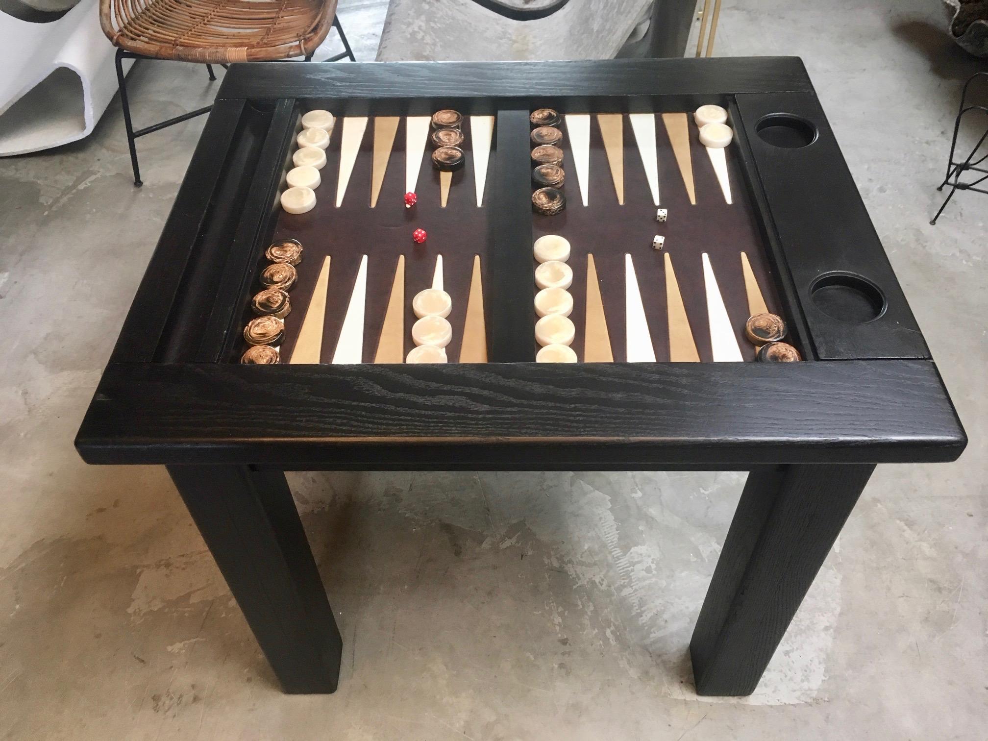Classic wood backgammon table with leather top. Oak frame and inset leather game board. Slot for backgammon pips on one side and two inset cup holders on the other. Perfect size. Great vintage condition. Vintage backgammon pieces included with sale.