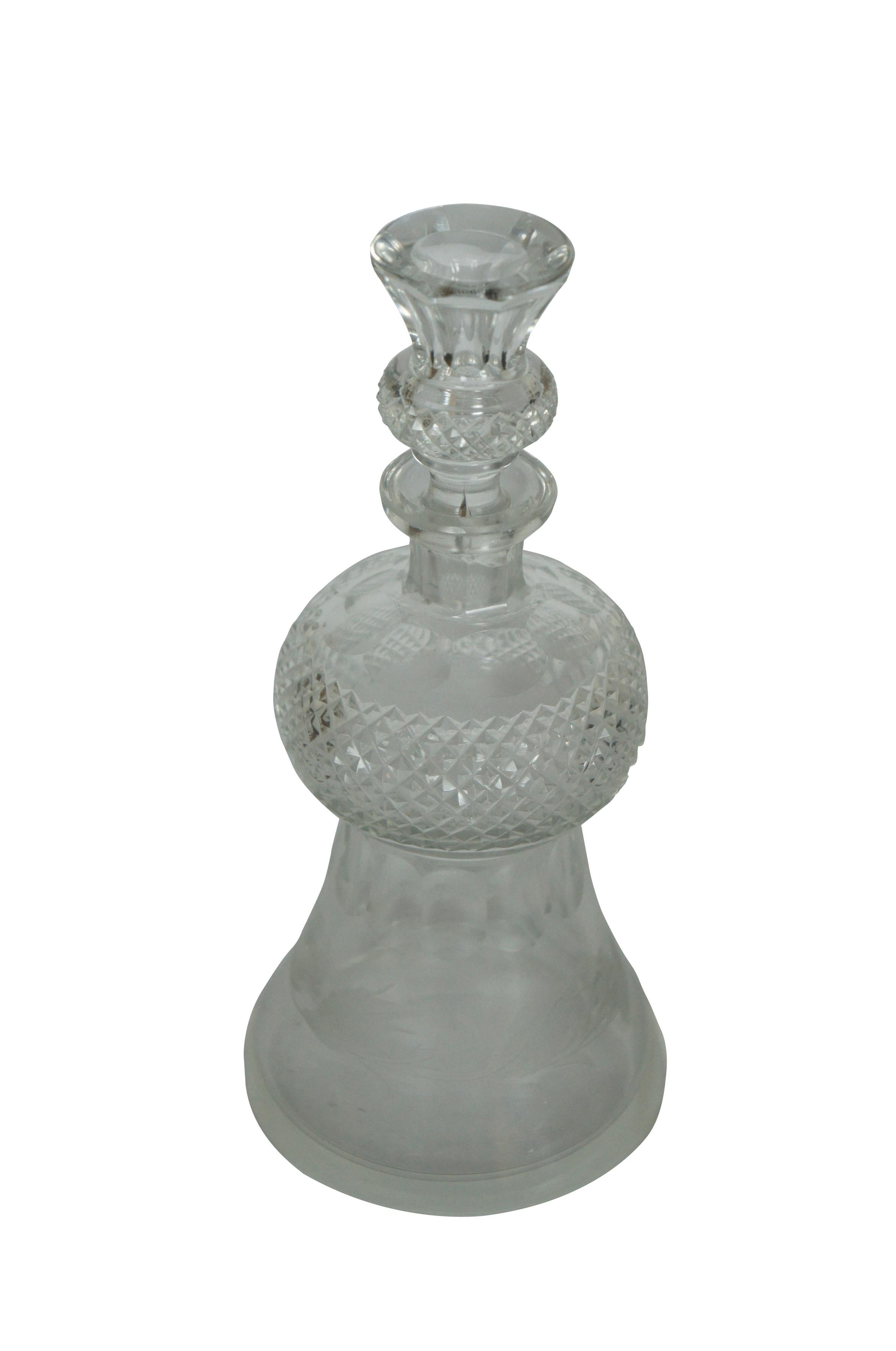 20th century crystal decanter featuring a unique thistle blossom shape with a flared base decorated with etched thistle blossoms and leaves and thumbprint detail, tapering to meet a round diamond cut middle and faceted mouth, echoed by the matching
