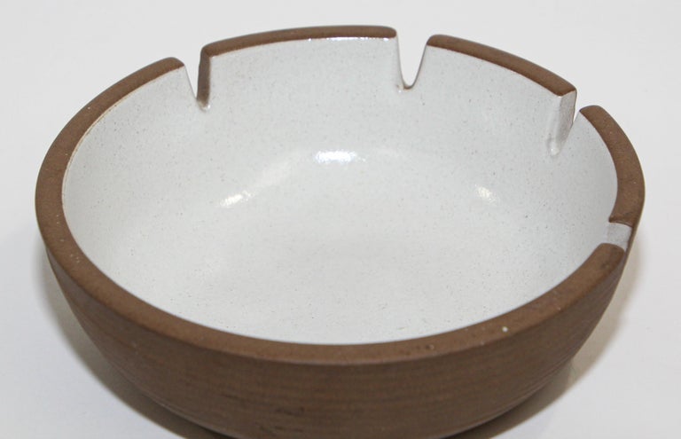 Vintage Mid-Century Modern ceramic ashtray by Edith Heath
Mid-Century Modern large vintage pottery ashtray by Edith Heath for Heath Ceramics. 
Glazed white sand color ironstone with brown unglazed bottom.
Bottom Reads 