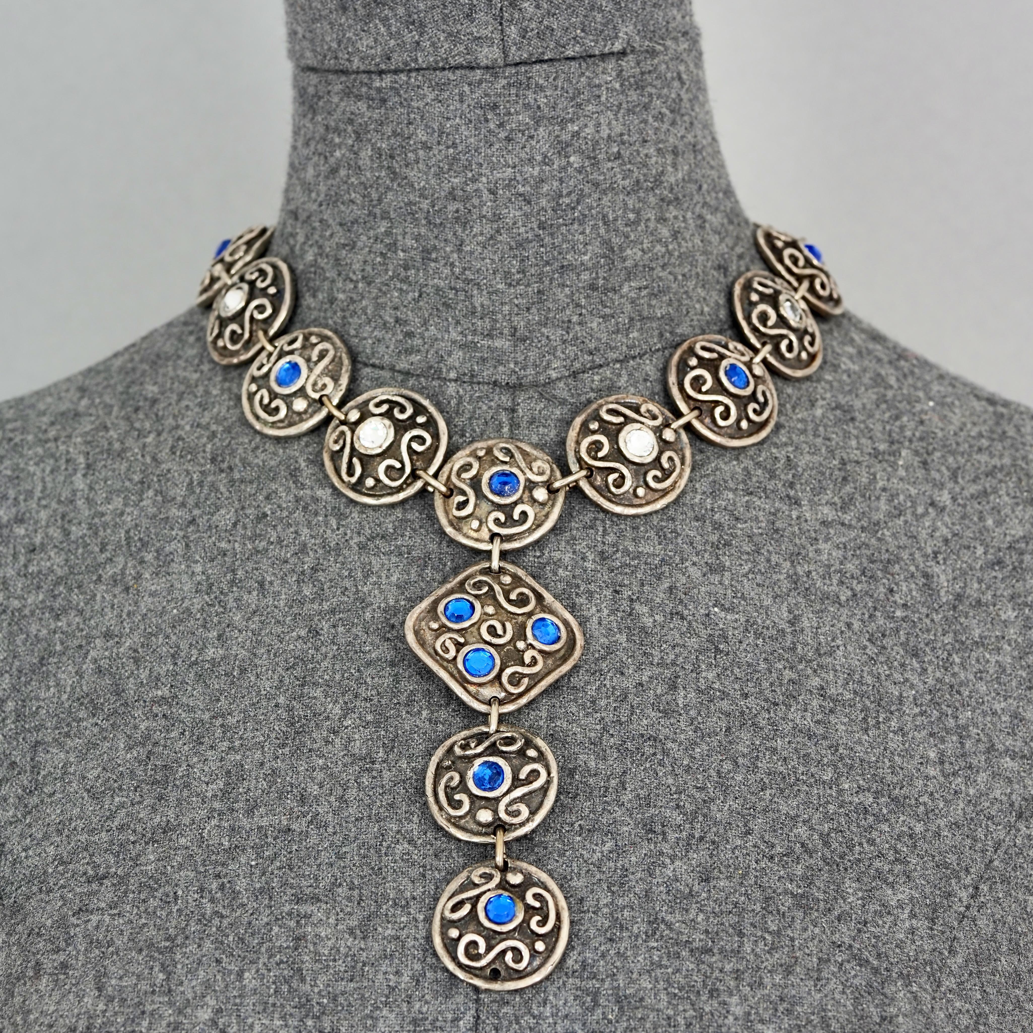 Vintage EDOUARD RAMBAUD Ethnic Jewelled Disc Link Necklace

Measurements:
Centrepiece Height: 5.11 inches (13 cm)
Discs: 1.10 inches (2.8 cm)
Overall Length: 17.12 inches to 19.48 inches (43.5 cm to 49.5 cm)

Features:
- 100% Authentic EDOUARD