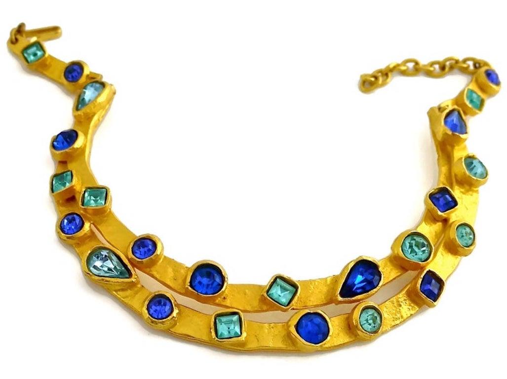 Vintage EDOUARD RAMBAUD Sapphire and Capri Blue Rhinestone Rigid Choker Necklace

Measurements:
Height: 0.78 inch (2 cm)
Wearable Length: 12.6 inches (32 cm) to 13.38 inches (34 cm)

Features:
- 100% Authentic EDOUARD RAMBAUD.
- Rigid choker with