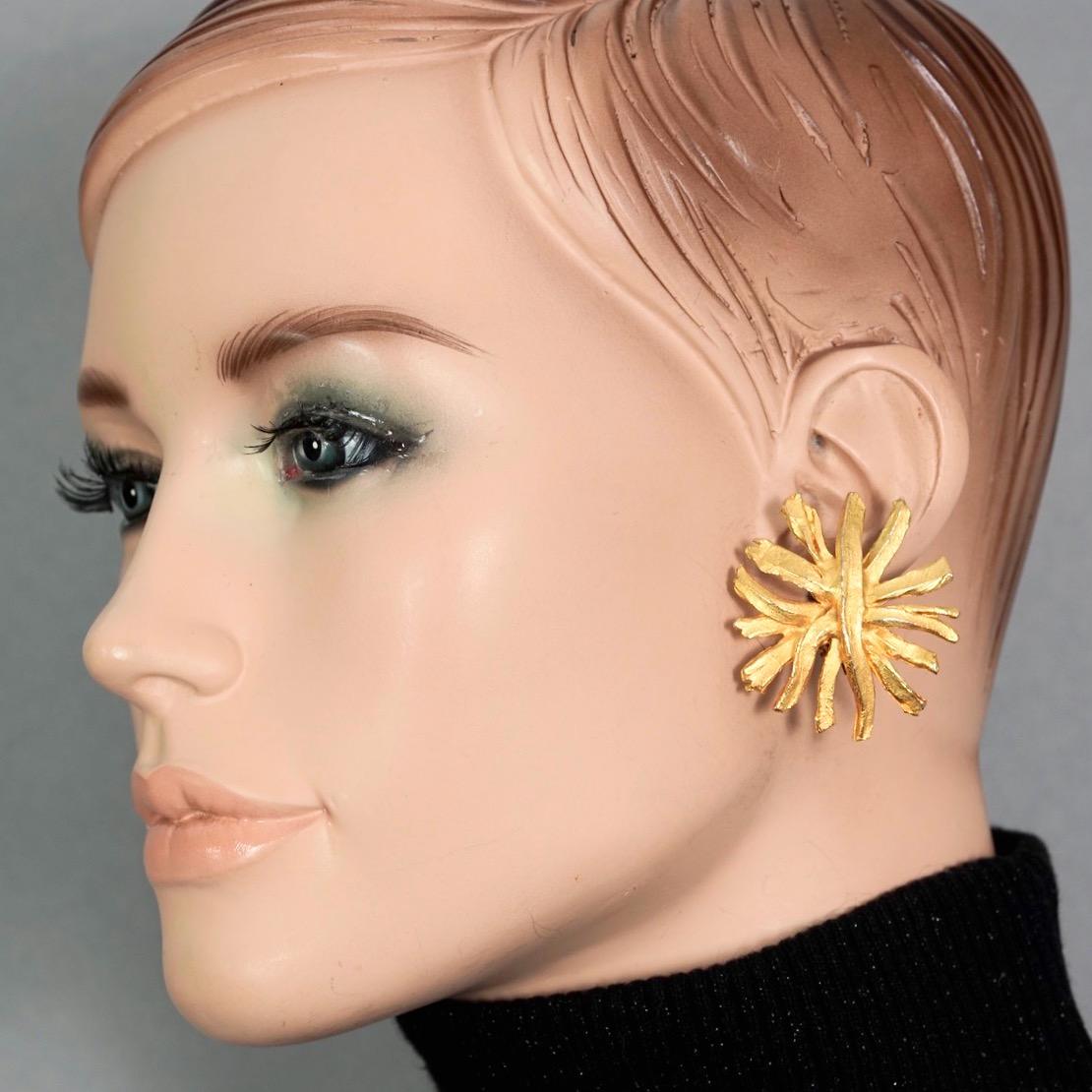Vintage EDOUARD RAMBAUD Sunburst Textured Earrings

Measurements:
Height: 1.69 inches (4.3 cm)
Width: 1.53 inches (3.9 cm)
Weight per Earring: 12 grams

Features:
- 100% Authentic EDOUARD RAMBAUD.
- Textured sunburst earrings.
- Gold tone