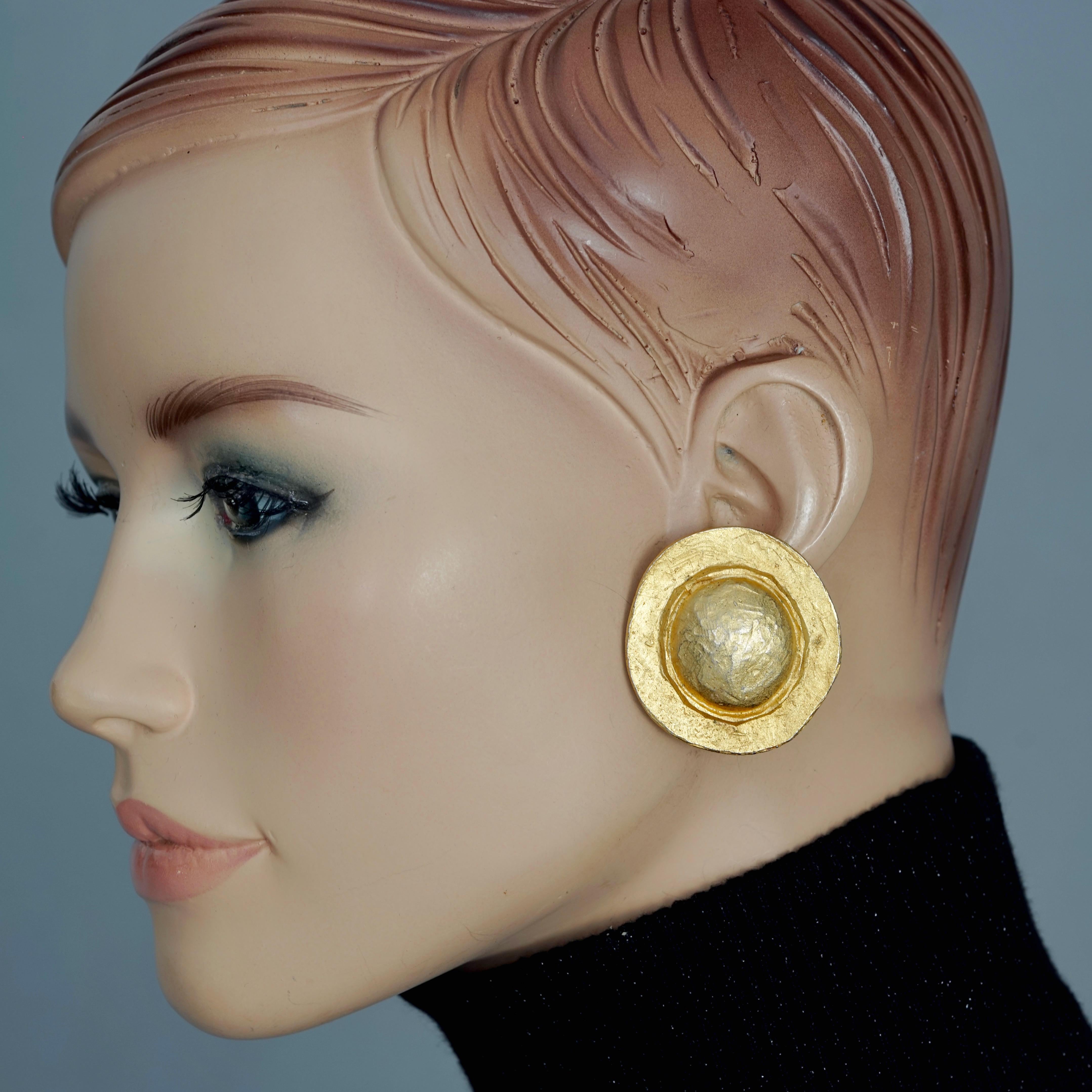 Vintage EDOUARD RAMBAUD Textured Disc Earrings

Measurements:
Height: 1.57 inches (4 cm)
Width: 1.57 inches (4 cm)
Weight per Earring: 17 grams

Features:
- 100% Authentic EDOUARD RAMBAUD.
- Textured disc earrings.
- Gold tone hardware.
- Clip back