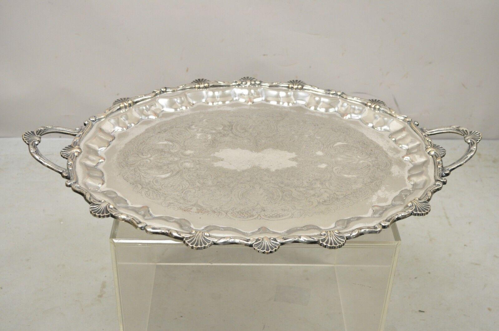 Large Vintage Edward San Giovanni Silver Plated Shell Form Twin Handle Platter Tray. Item featured is a large impressive size, ornate shell form, twin handles. Circa Early to Mid 20th Century. Measurements: 2.5