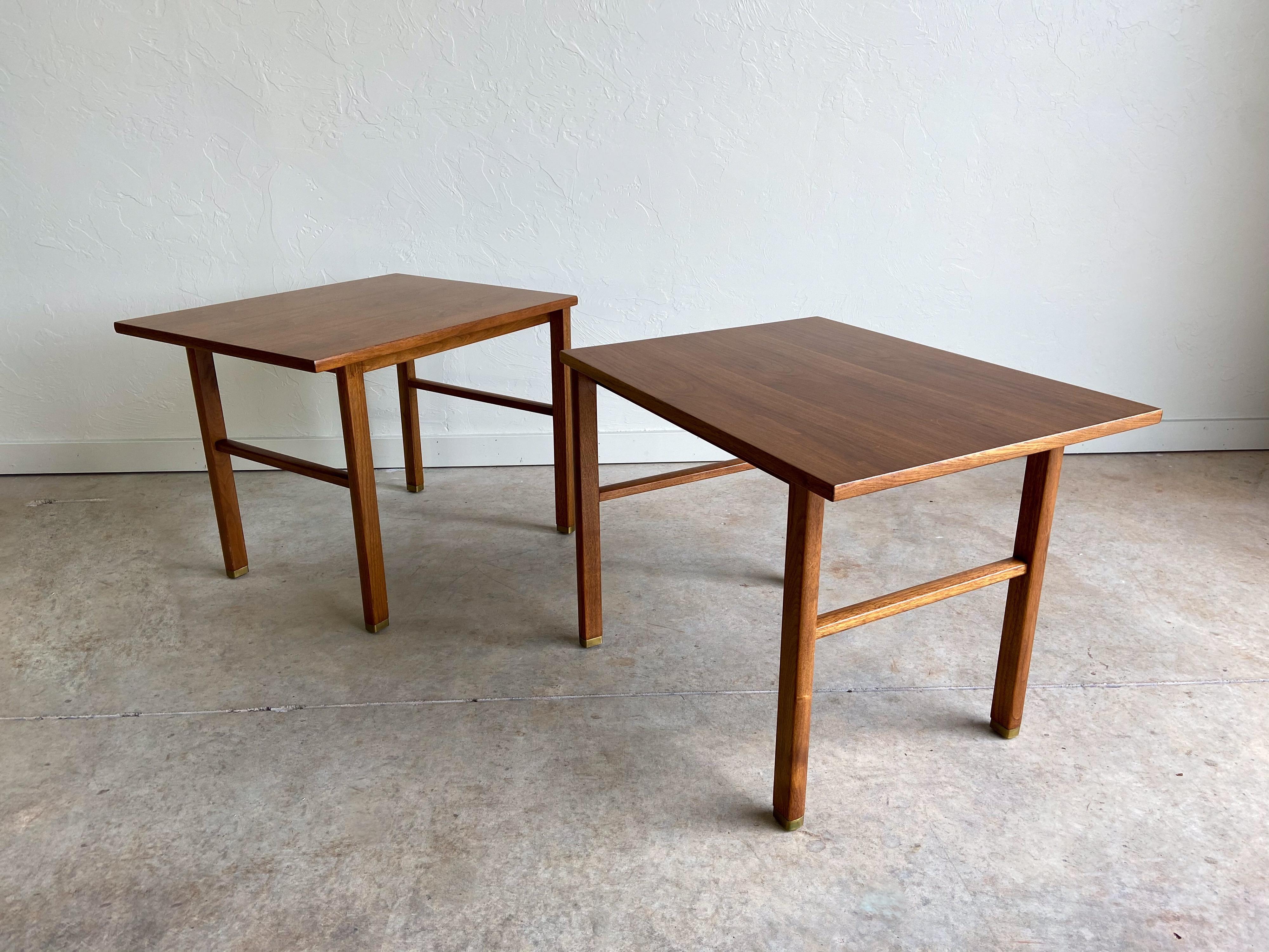 A pair of cantilever side tables designed by Edward Wormley for Dunbar. A simple, elegant design. Each retains its original Dunbar label. 

        