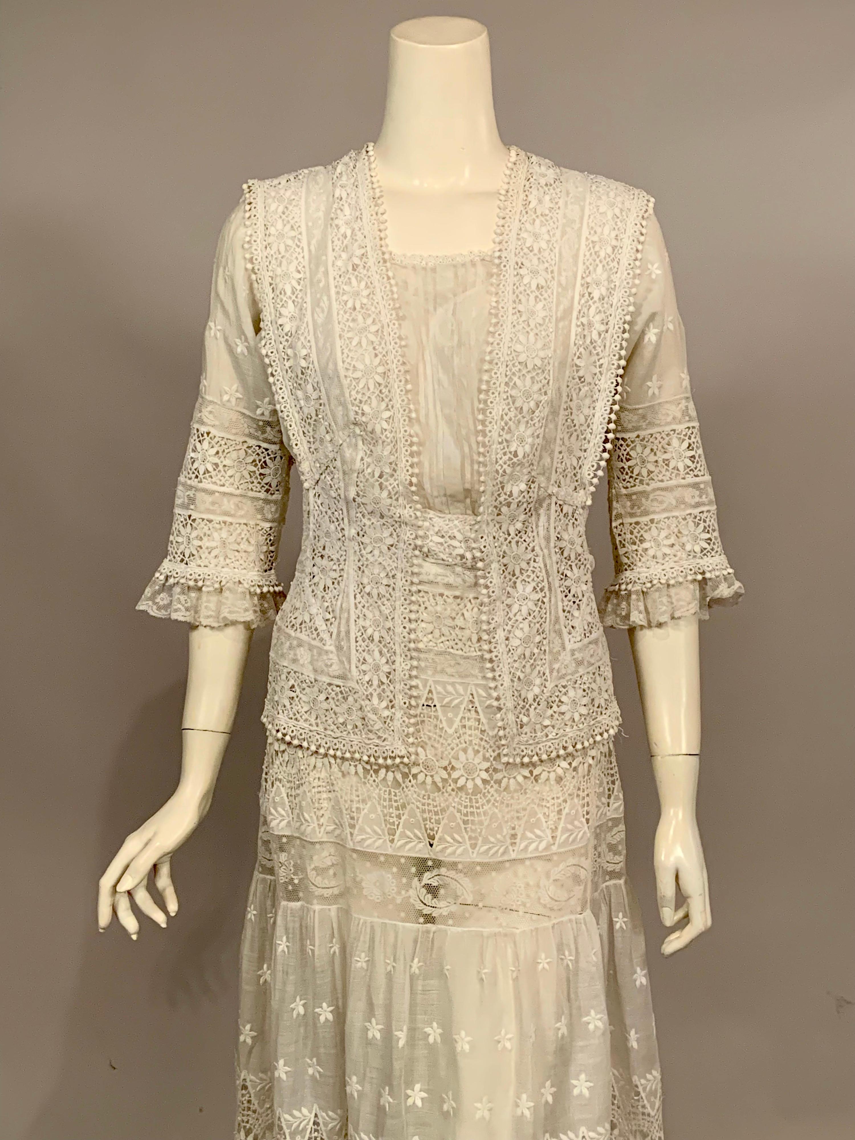 This vintage Edwardian Dress has all of the bells and whistles It has a square neckline, a left side of center front opening, three quarter length ruffled lace sleeves, and a faux 