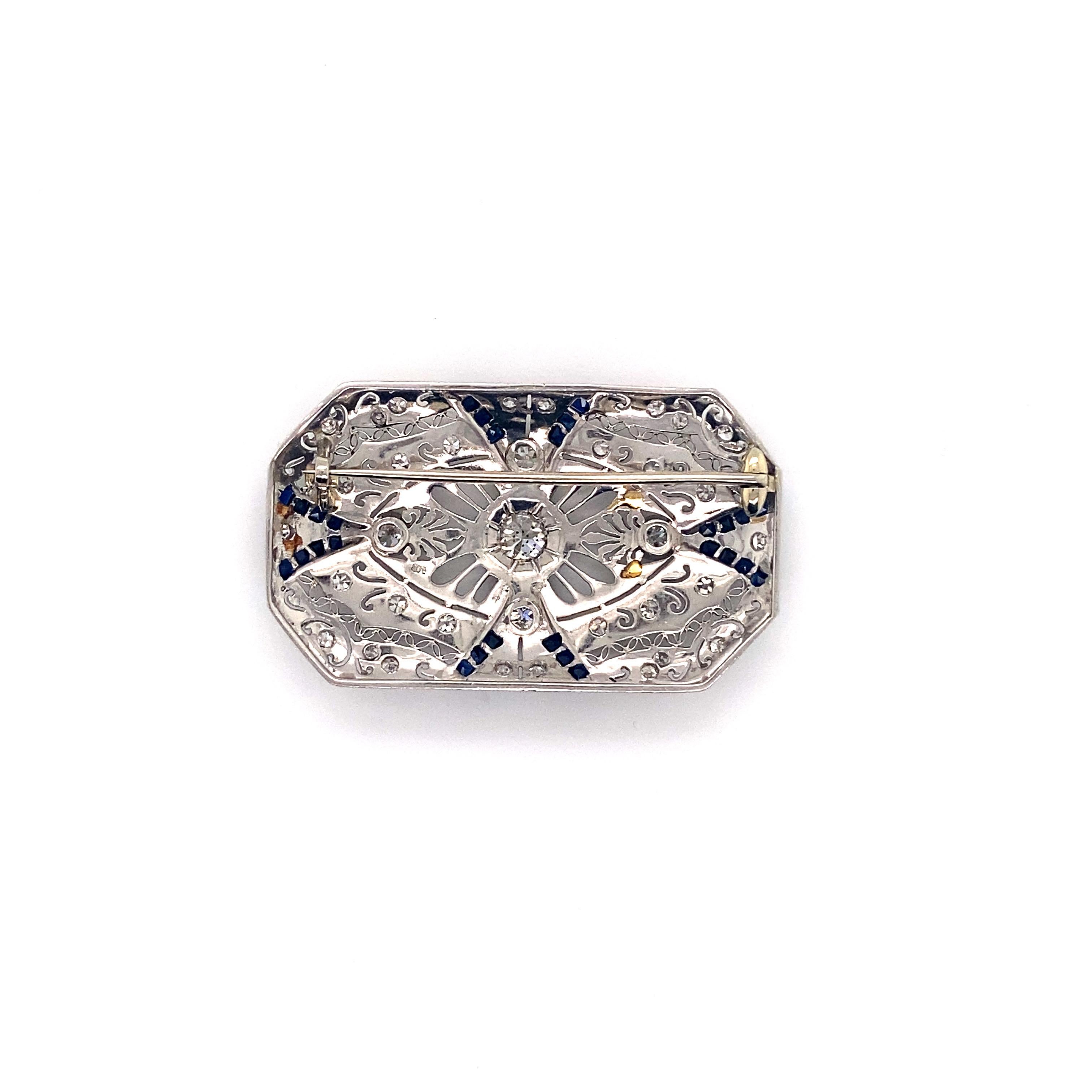 Vintage Edwardian Platinum Diamond and Sapphire Filigree Brooch - The center Eurpopean cut diamond is set in a hexagon plate and weighs approximately .50ct. There are 4 European cut diamonds set in bezels and weigh approximately .40ct total weight.