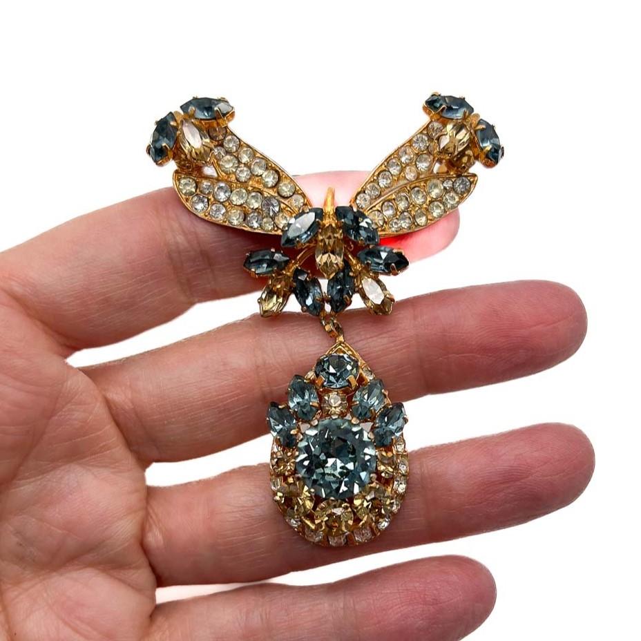 A Vintage Edwardian Inspired Topaz Brooch. A high quality, delightful bow inspired bar with an ornate pendant drop. Encrusted with blue and yellow topaz crystals in fancy cuts. Dreamy design inspired by jewels from the Edwardian era. A romantic