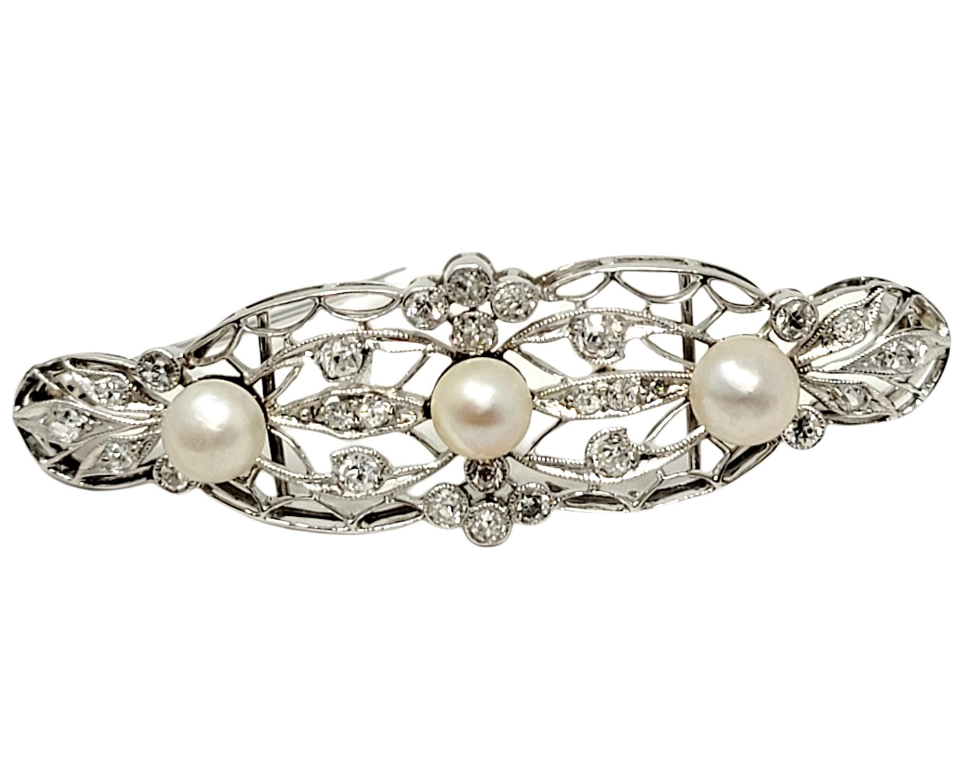 Exquisite vintage Edwardian style filigree brooch with delicate diamond and pearl accents. 

Metal: 14K White Gold
Closure: Hinged stick pin
Cultured Pearls: 3
Natural Diamonds: .50 ctw 
Diamond Cut: Old European
Diamond Color: E-F
Diamond Clarity: