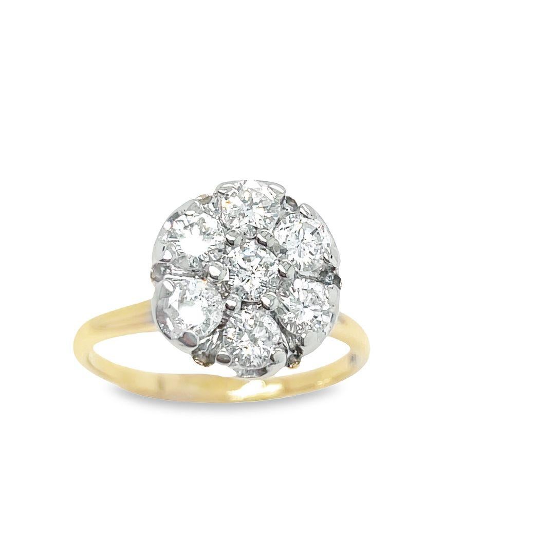 This Edwardian styled vintage diamond ring is the epitome of elegance, exuding charm and style. Crafted in 14K yellow gold, the ring features seven round diamonds clustered together in a high crown design. The total carat weight of the diamonds is