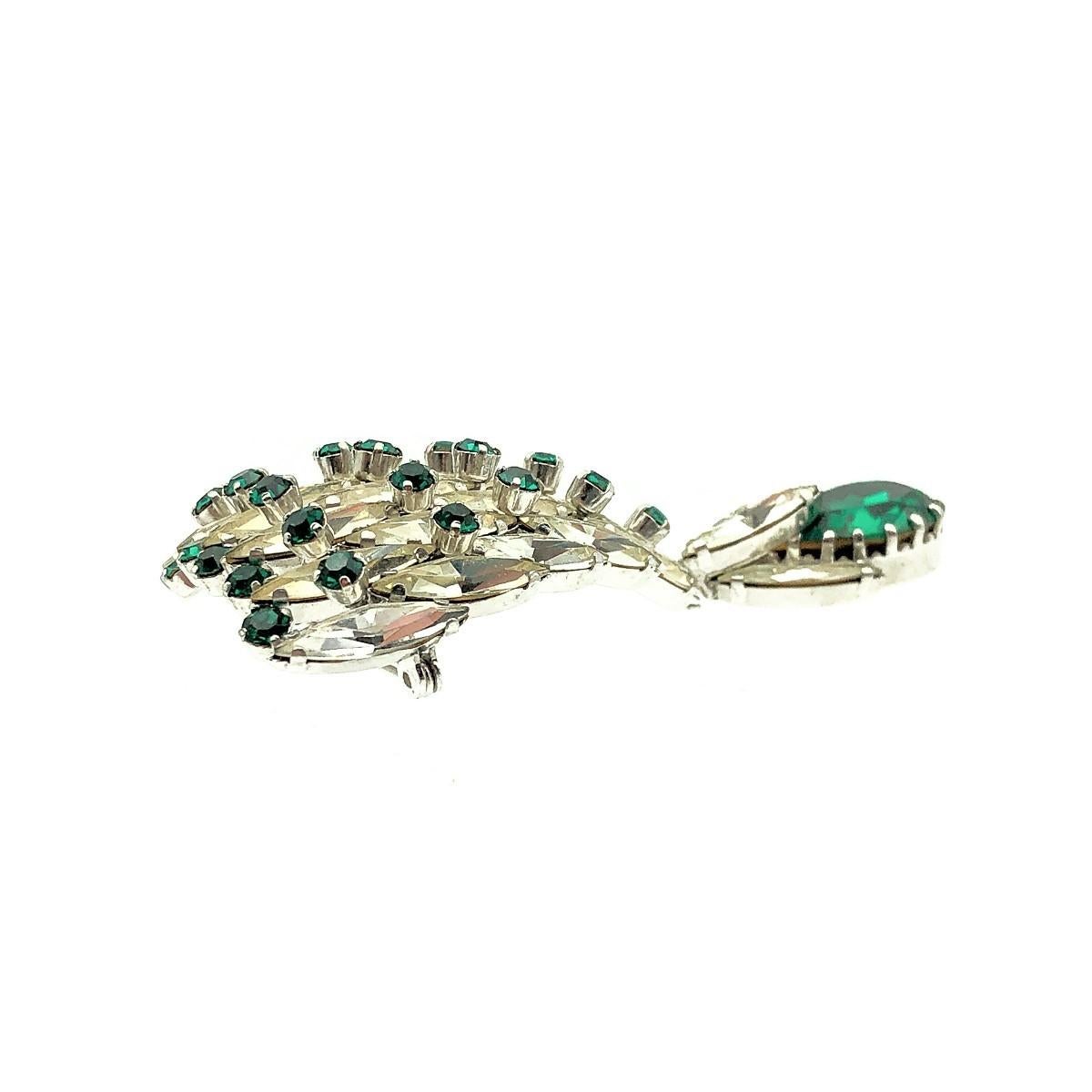 An especially captivating vintage EFBI Austria Emerald Brooch and Earrings demi parure, dating to the glorious 1950s. Crafted with high quality emerald and white crystals in rhodium plated metal. The brooch features a rare and eye-catching arched