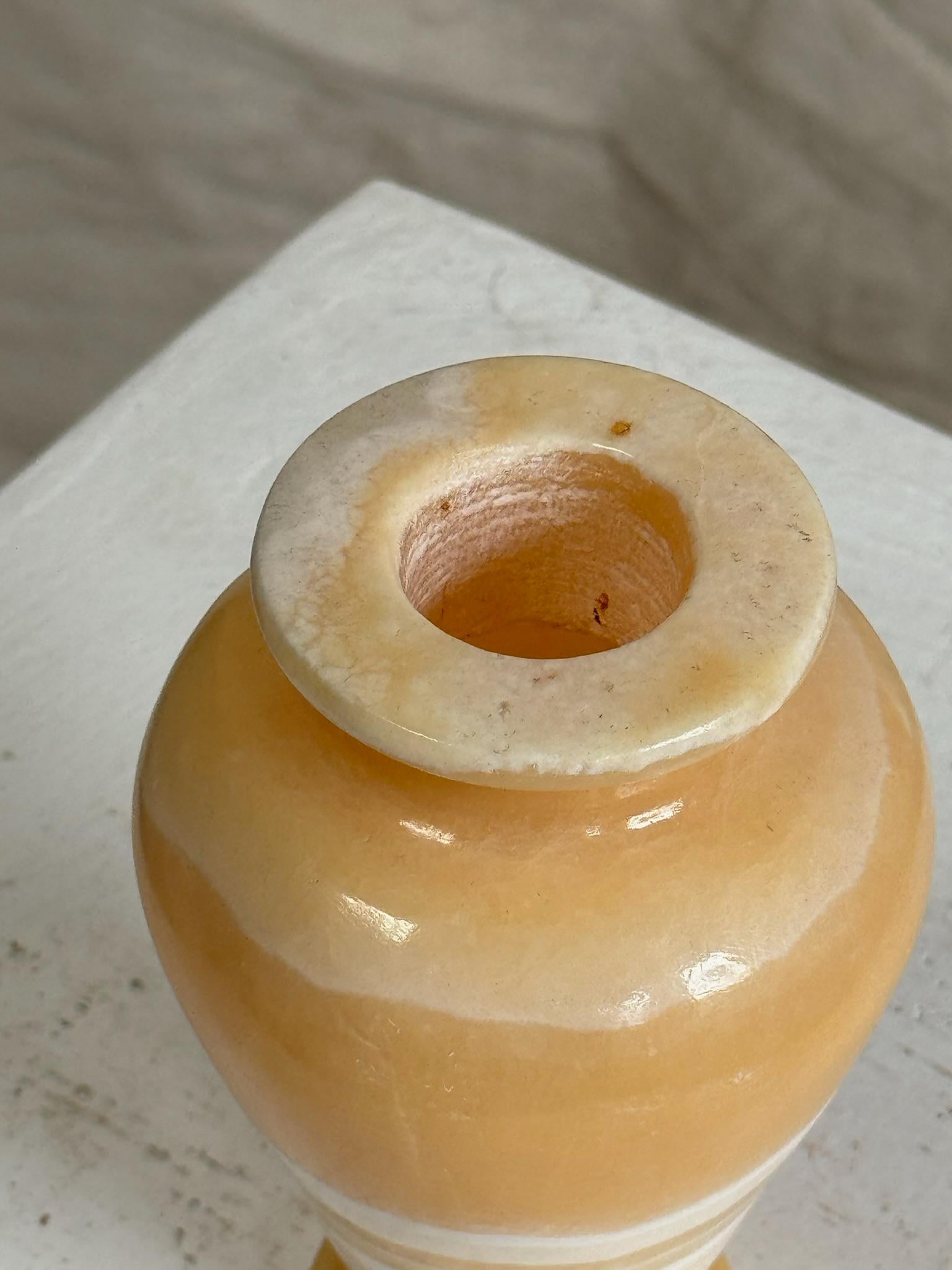 This honey beige white late 20th-century vase embodies the rich tradition of stone craftsmanship dating back to ancient Egypt. Utilizing materials like onyx and alabaster, prized by Egyptian artisans for millennia, this vase pays homage to the