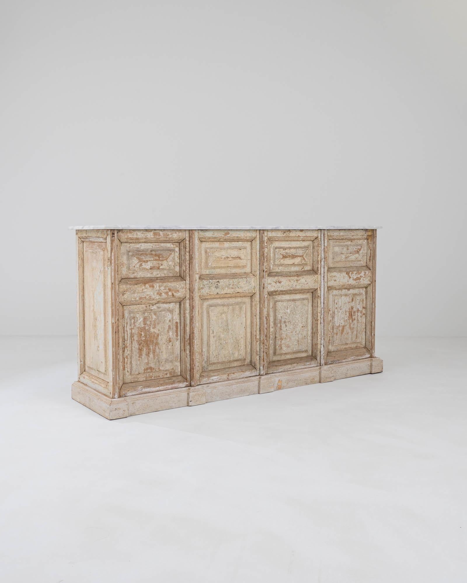 Sourced in Northern Africa, this striking patinated bar was constructed by artisans from vintage wooden doors. Formerly serving as entryways and passages in the imposing palatial townhomes where these paneled doors were once commonplace. The