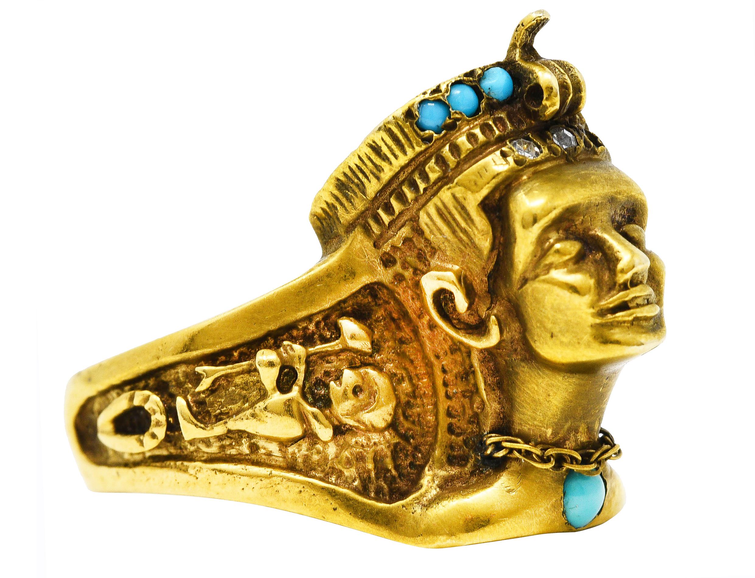 Ring is designed as a highly rendered bust of the Egyptian queen Nefertiti with a decorative headdress. Featuring flush set turquoise cabochons in headdress and on chest - ranging in size from 1.0 to 2.5 mm. Opaque and ranging in color from robin's