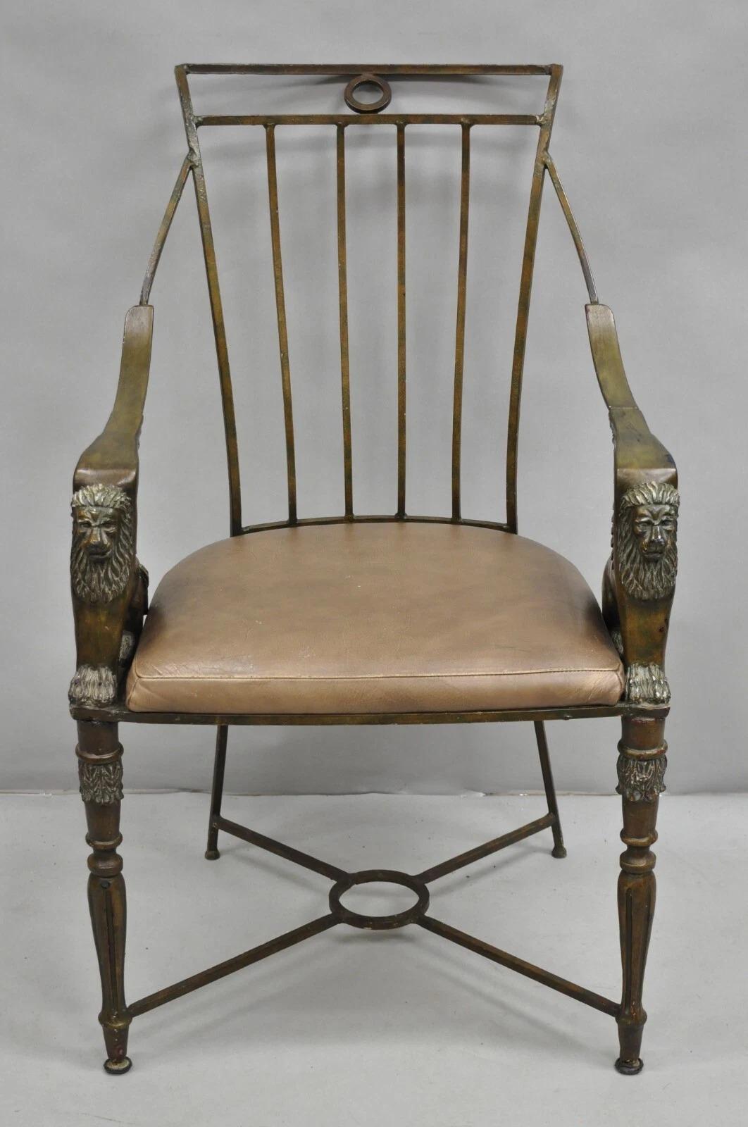 Vintage Egyptian Revival Lion Sphinx Wrought Iron Regency Style Arm Chair. Item features a heavy iron frame with cast resin sphinx figures, leather seat, and cross stretcher base. Circa Late 20th Century. Measurements: 37