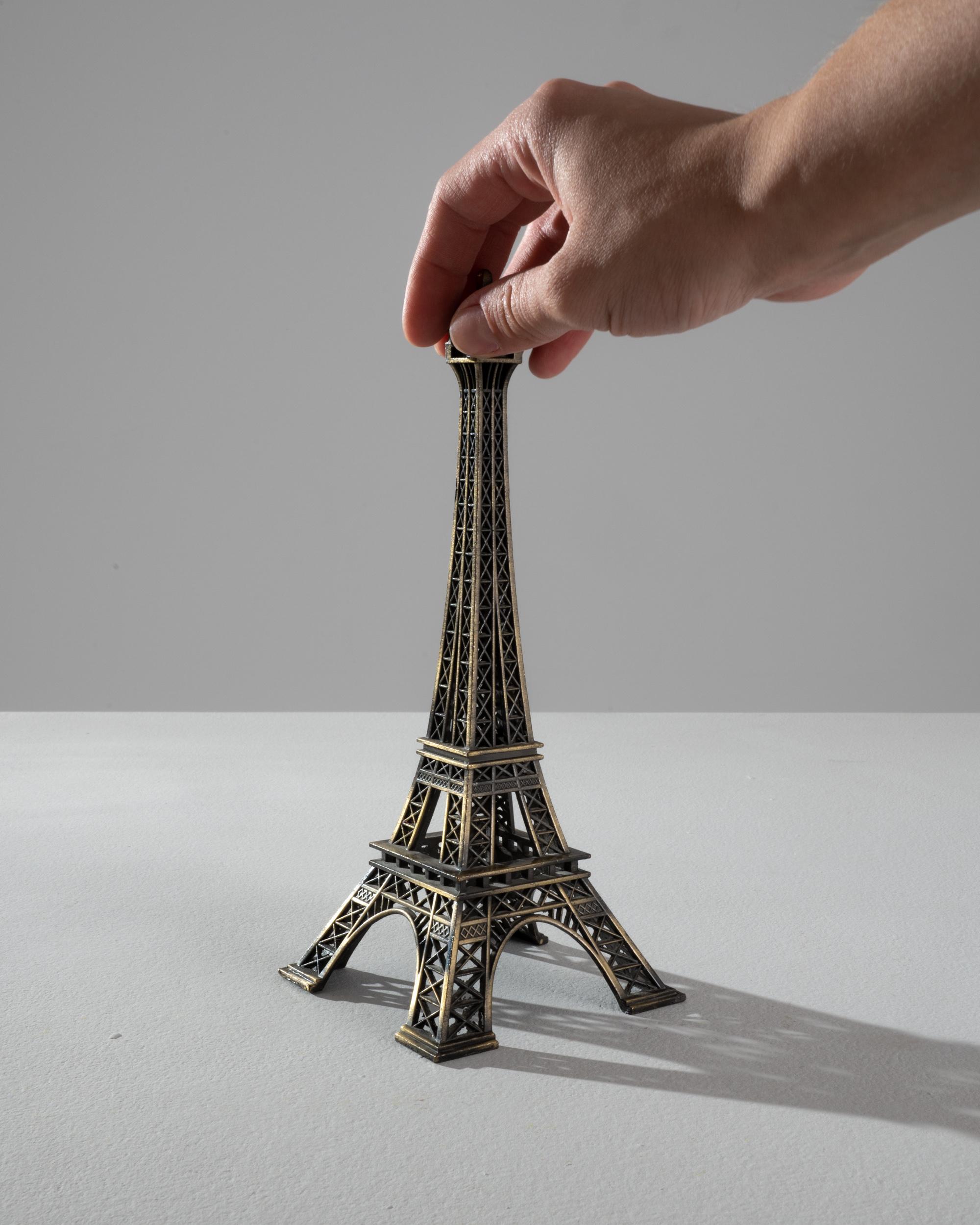 This brass decoration, in the shape of the Eiffel tower, conjures the romance of a voyage to Paris. Made in France in the 20th Century, the intricate lattice-work is rendered in perfect detail, bringing the iconic monument to life. The dark finish