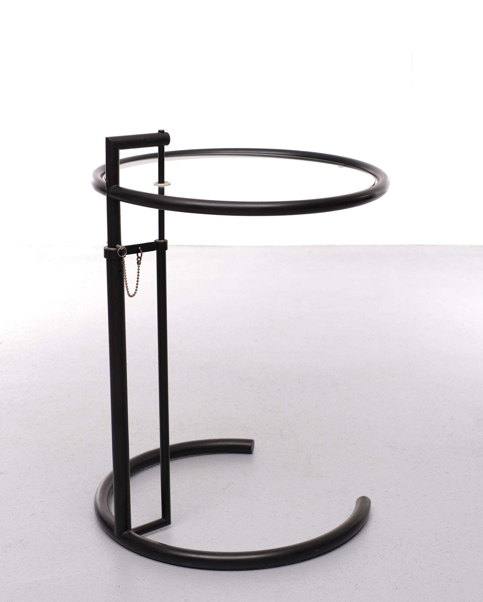 Eileen gray side table after a design of Eileen Gray in 1927. This is a later version of this side table from the eighties. Its adjustable height makes it highly practical; it can be used as a bedside table, a coffee table or as a side table. It has