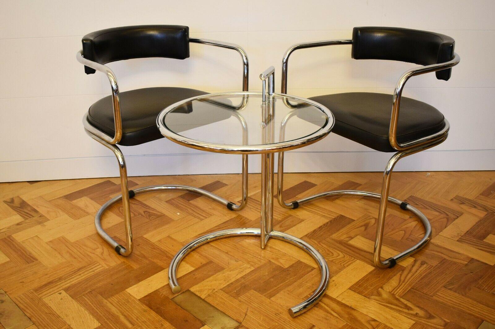 Eileen gray pair of armchairs and side table set, circa 1970's.

The Eileen gray side table and seating set is a well known and loved modern day classic furniture piece. Sleek and stylish, this piece embodies the simplistic elegance of mid century