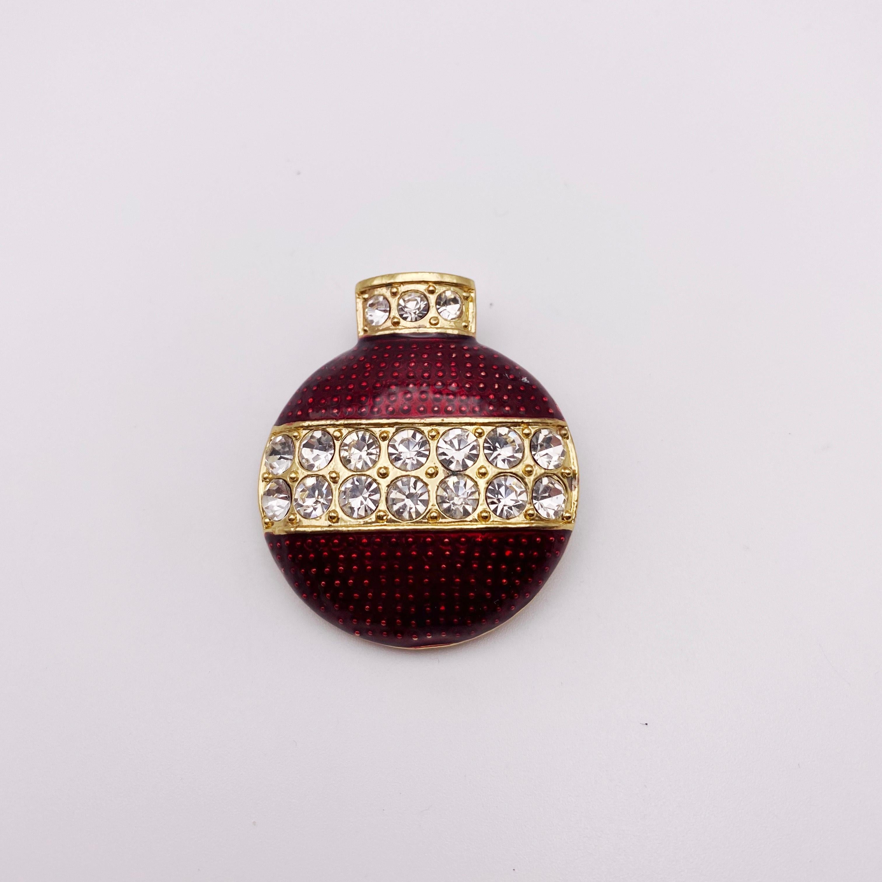 A beautiful Christmas bauble brooch by Eisenberg Ice. Circa, 1970s. Featuring red enamel with Swarovski crystals, set in gold plating.  

According to Judith Miller, Eisenberg costume jewellery is a favourite among collectors. Originally a clothing