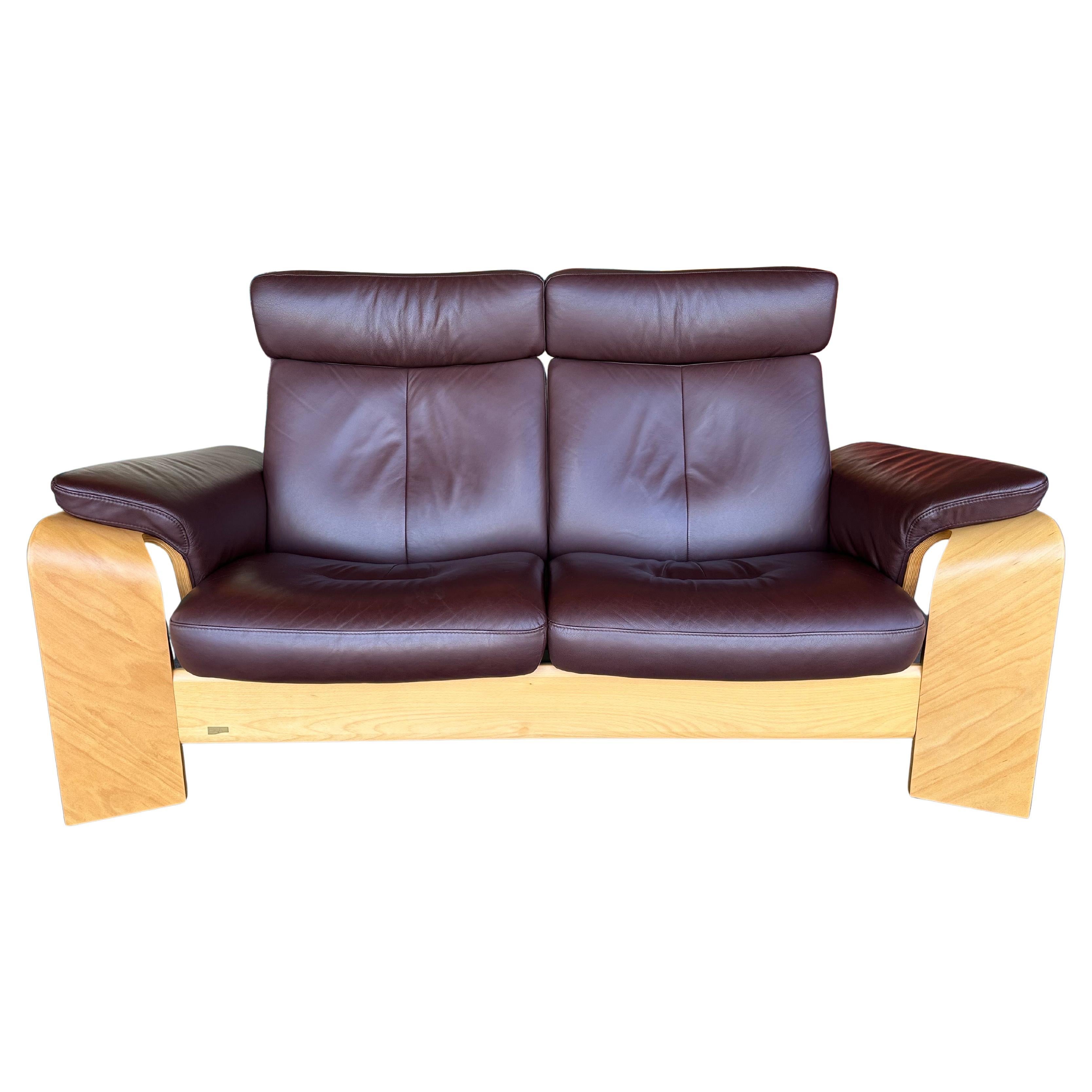 Vintage Postmodern Reclining Loveseat in brown leather and beech. Made by Ekornes Stressless Norway, well known for their extremely comfortable recliners. This is the Pegasus model produced in late 90’s/early 2000’s and is in excellent pre loved