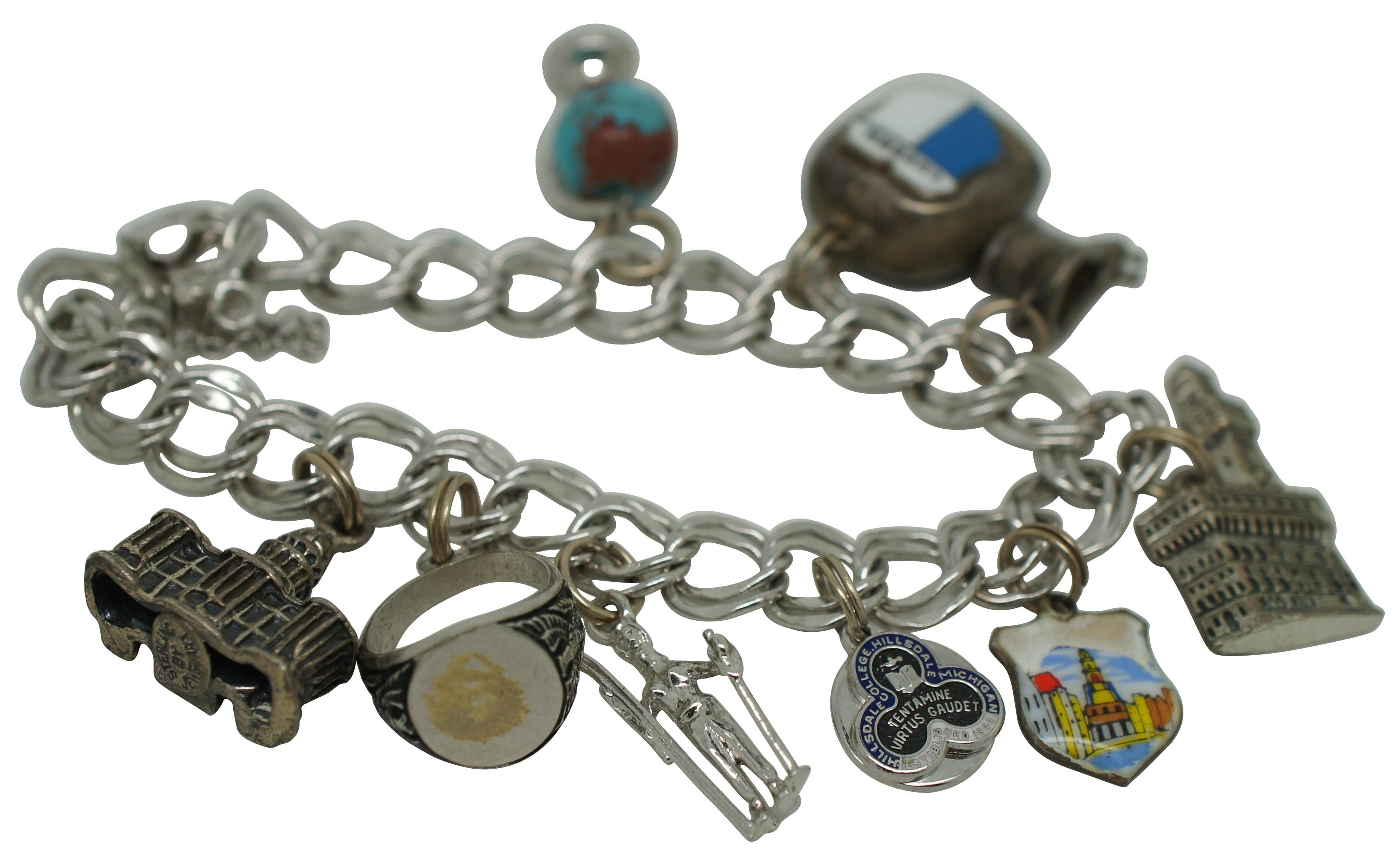 Vintage charm bracelet featuring an Elco sterling double link chain and open box clasp. Charms include a plastic globe with sterling stand, 800 silver bell with enamel Luzern shield, unmarked bidet, 800 silver Pallazzo Vecchio tower marked Firenze